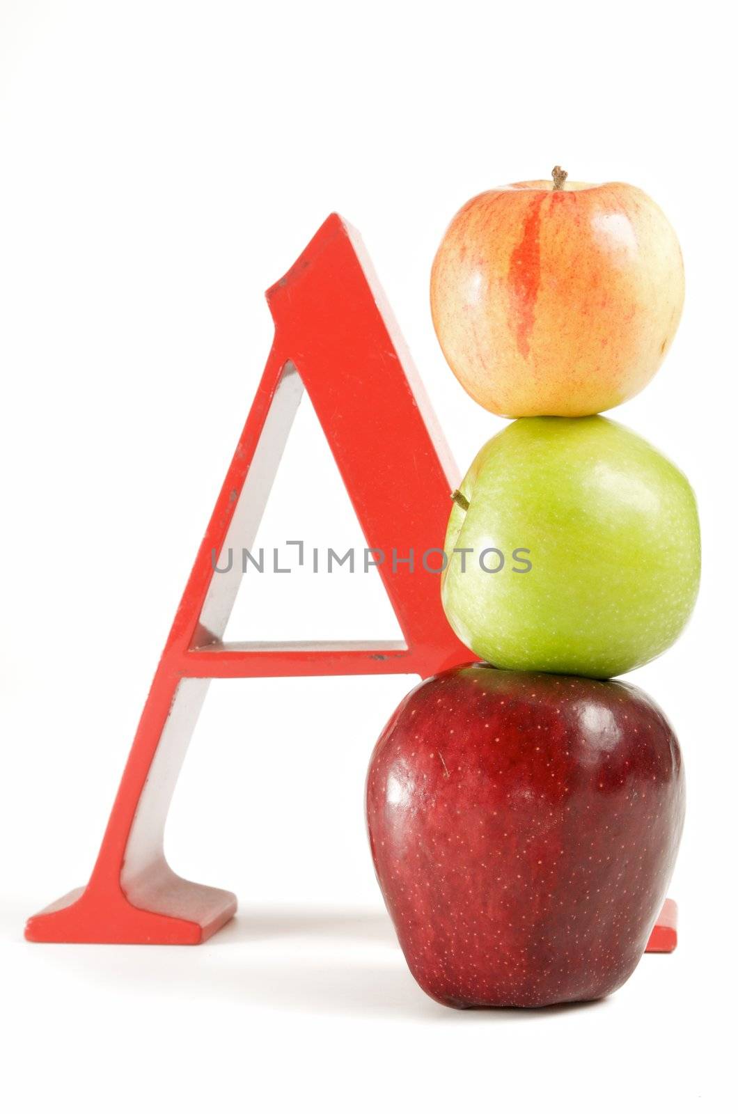 stack of apples in front of large red letter A