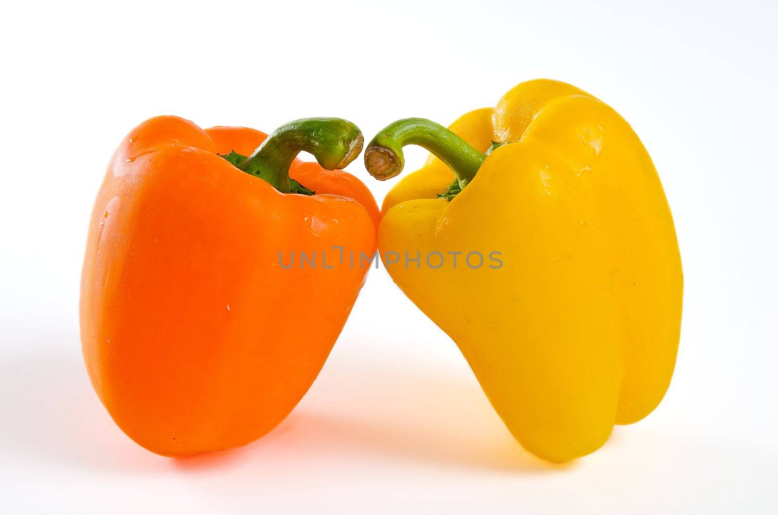 Two bell peppers leaning close together