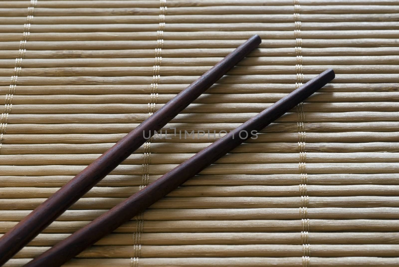 Chopsticks on a bamboo roll placemat