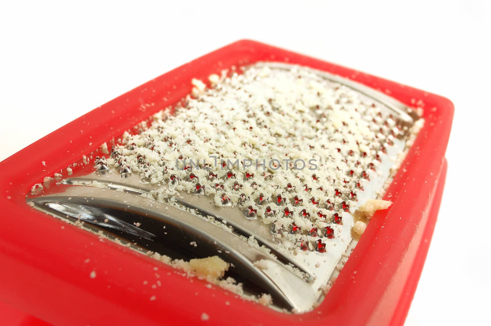 A closeup of red plastic parmesan grater