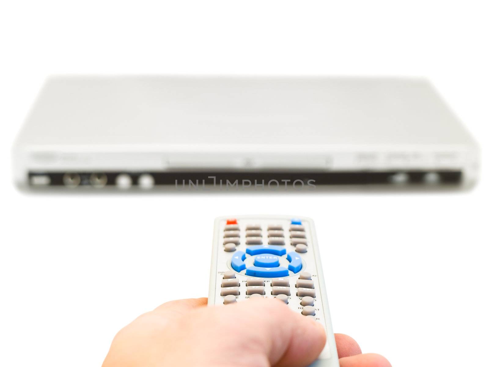 remote control in hand and dvd player over the white background