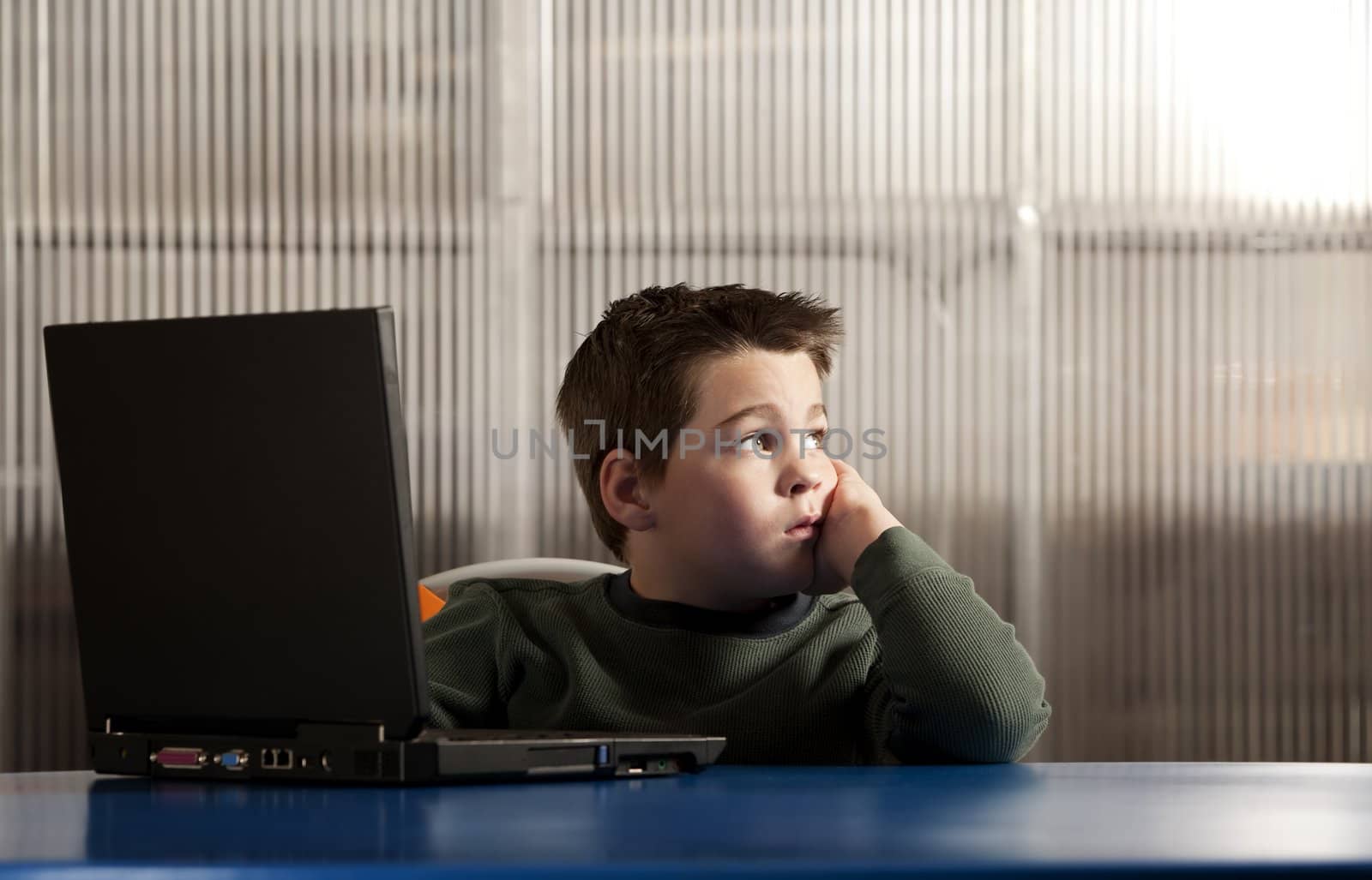 Cute young boy working on a laptop computer