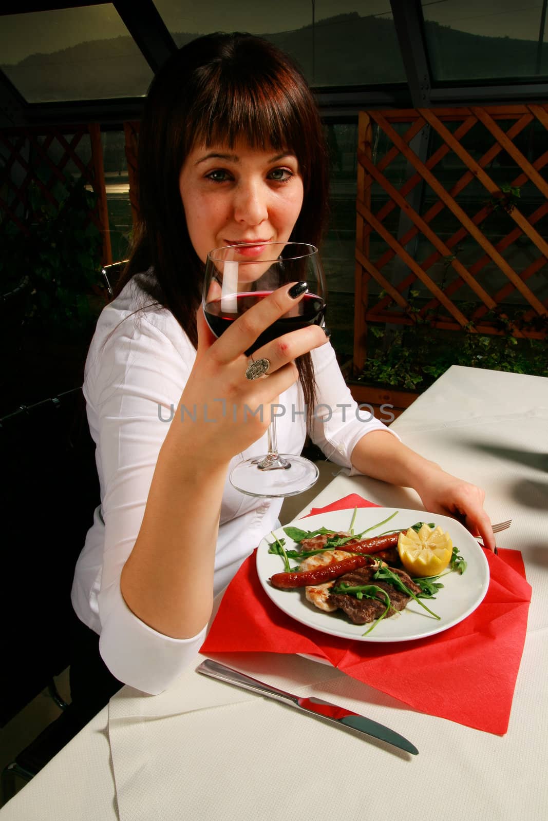 Young woman having some wine before dinner.