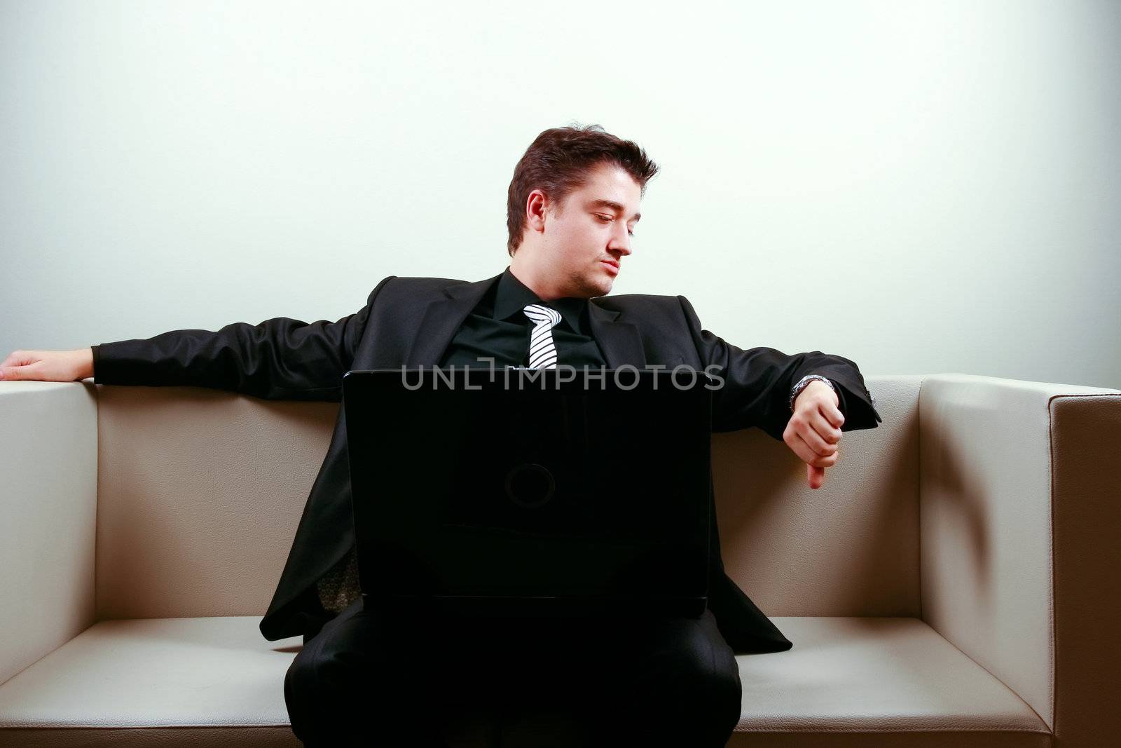 Businessman on lounge holding a laptop