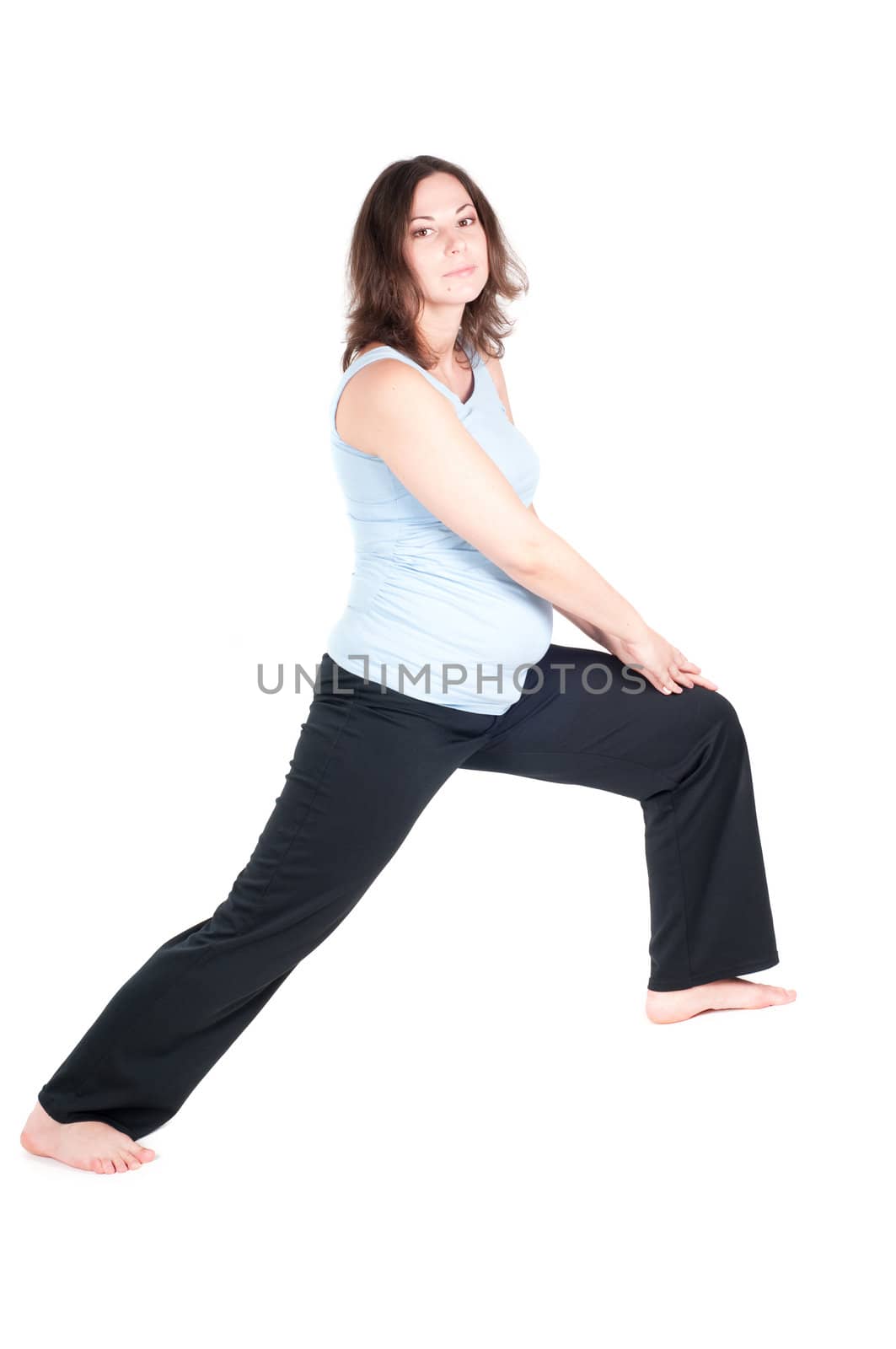 Portrait of pretty pregnant woman practicing physical exercise isolated on white