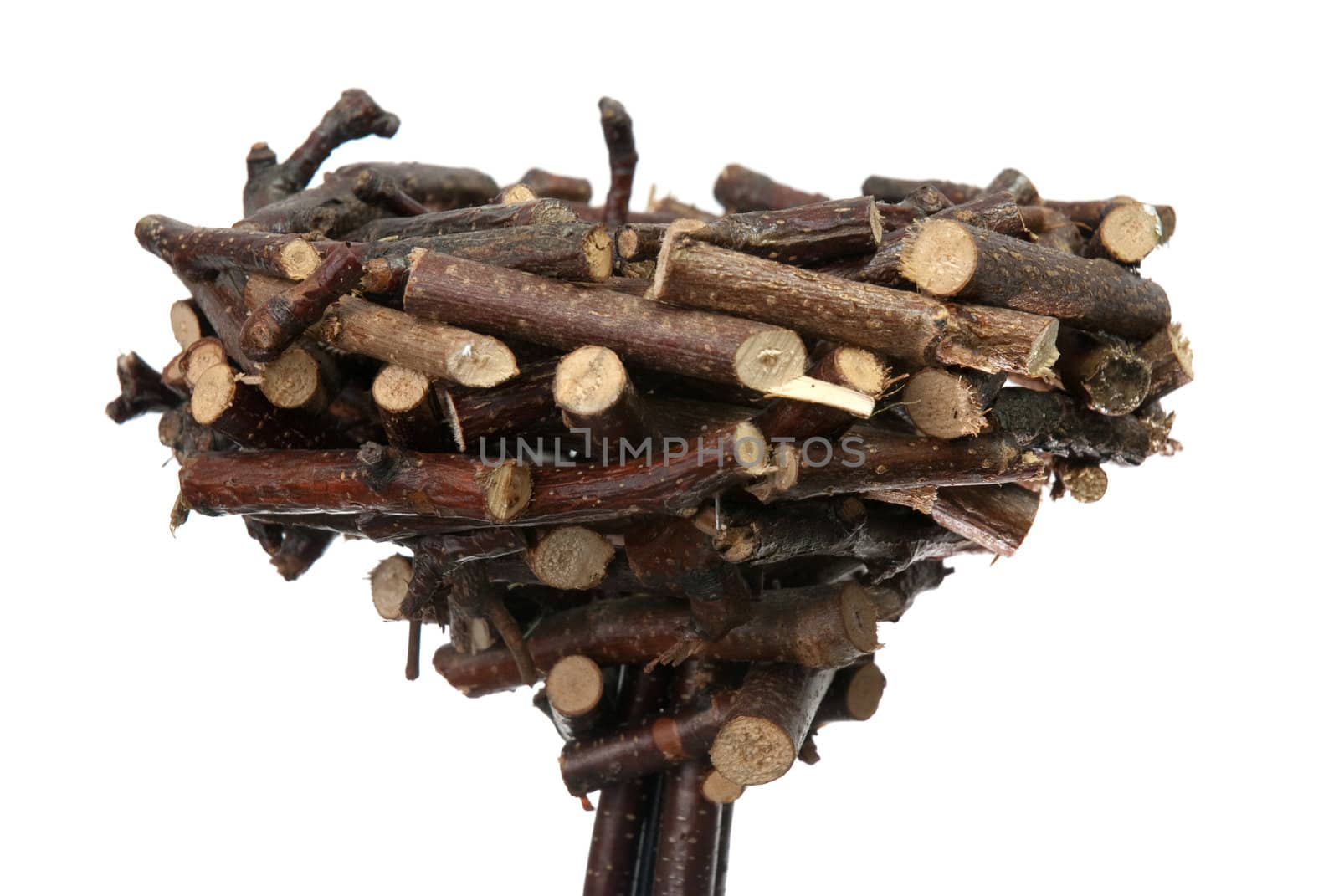 Decorative nest made of wood sticks isolated on white background.