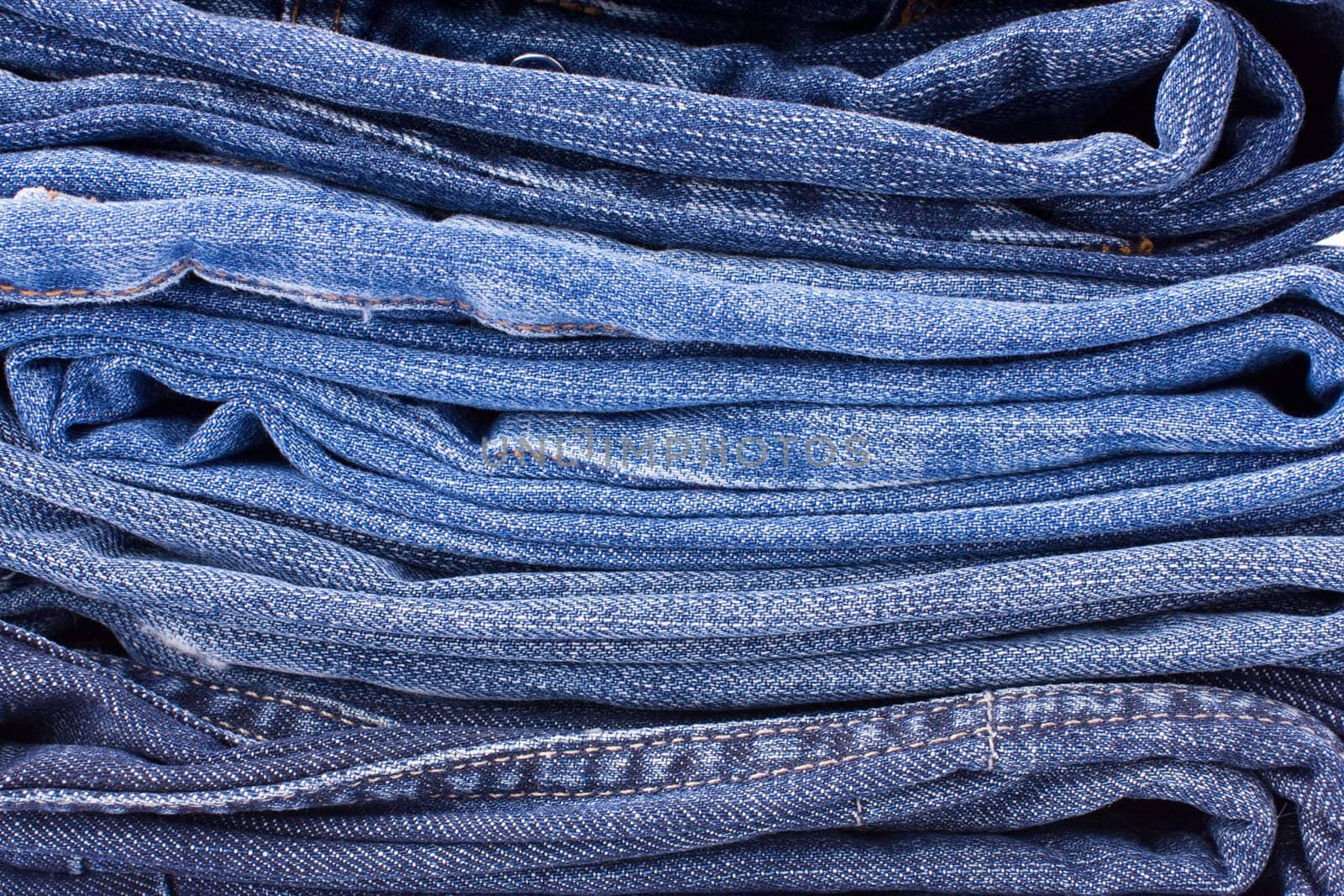 Stack of Blue Jeans Background by rozhenyuk