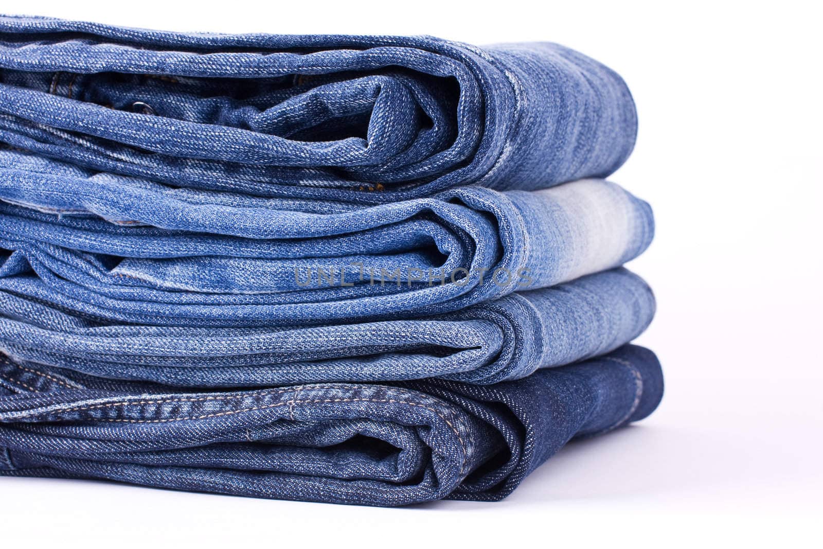 Stack of Blue Jeans isolated over white