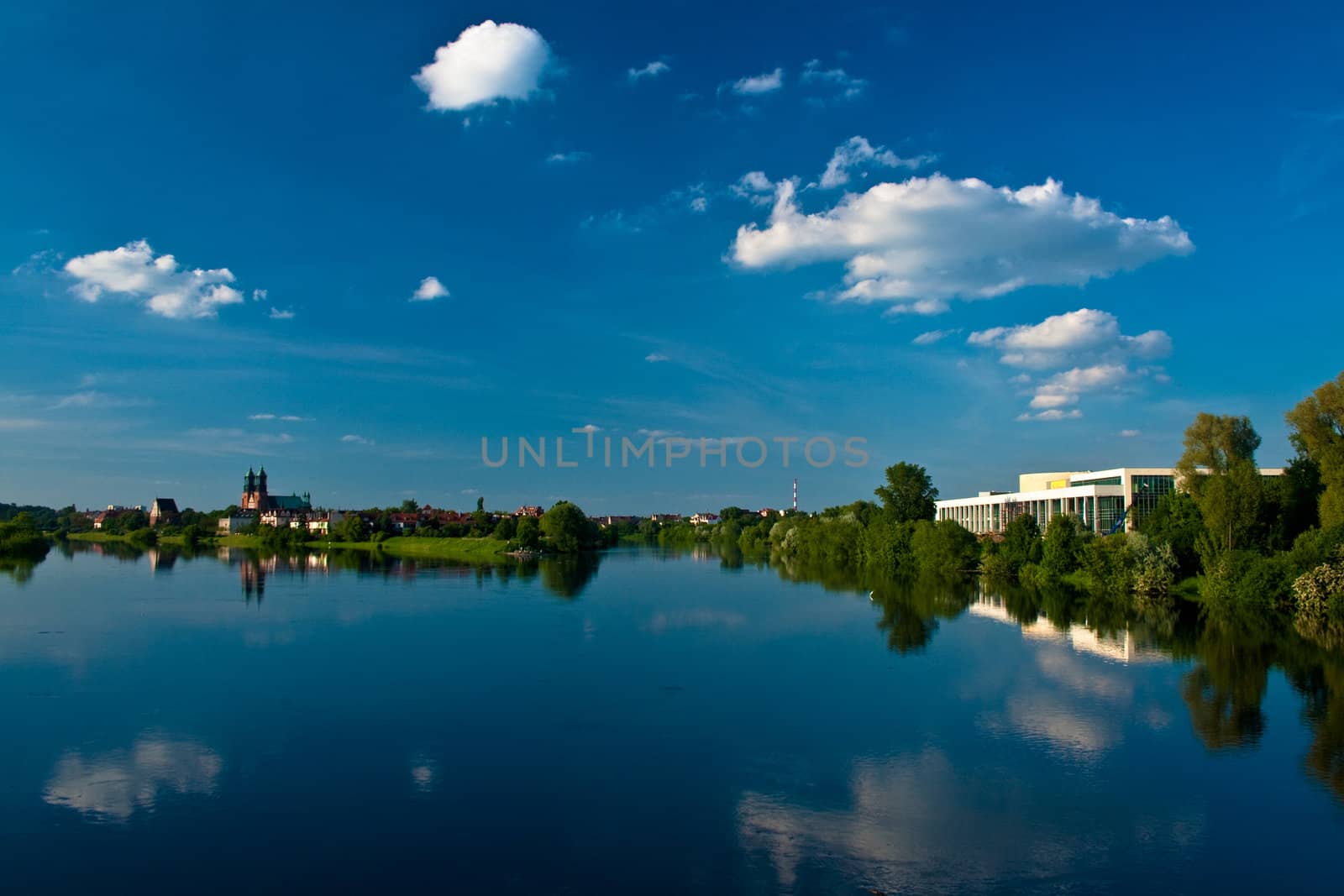 Sunny landscape at the river with clouds
