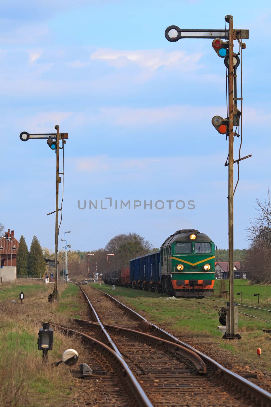 Freight train hauled by the diesel locomotive waiting at the station
