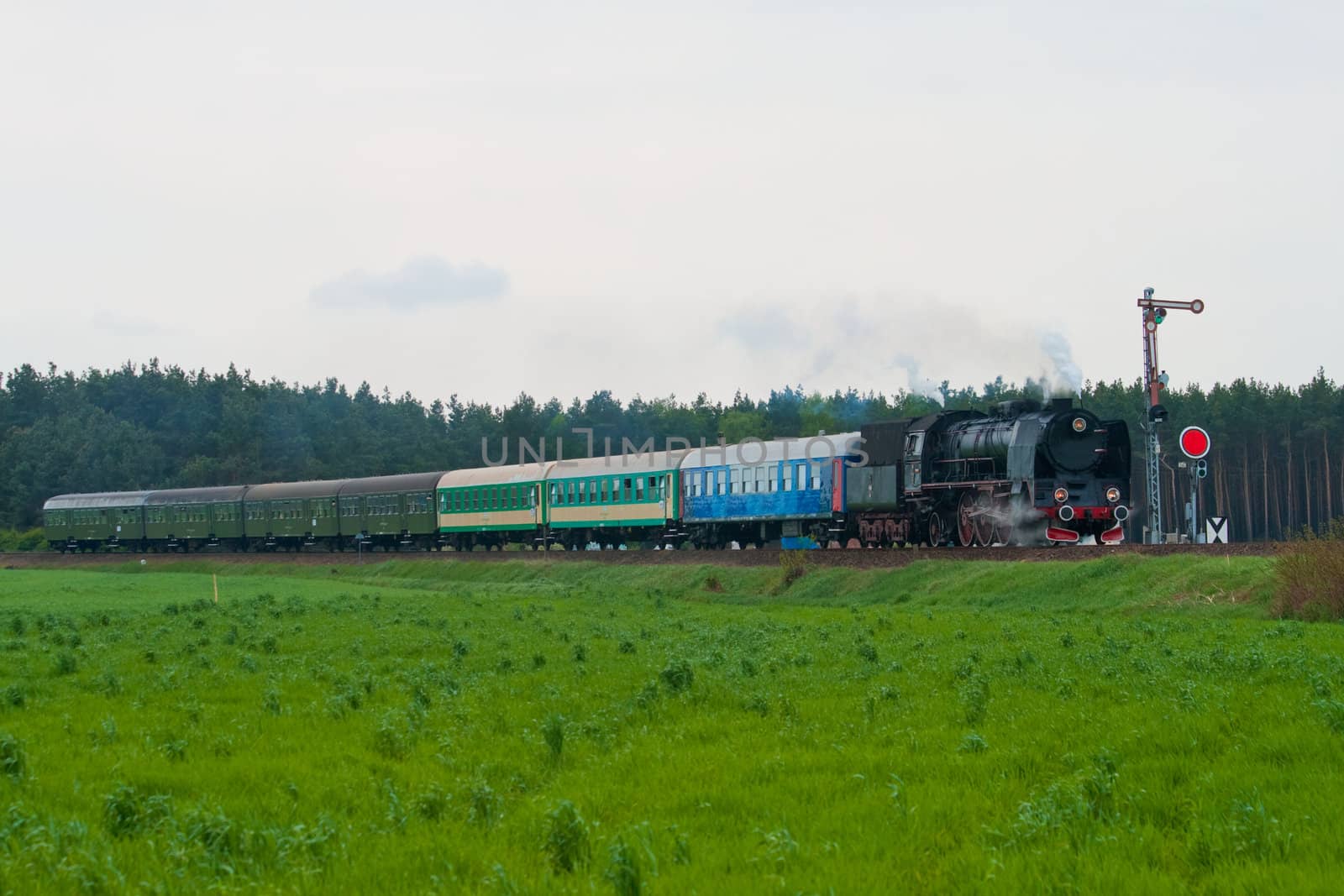 Old retro steam train passing through polish countryside
