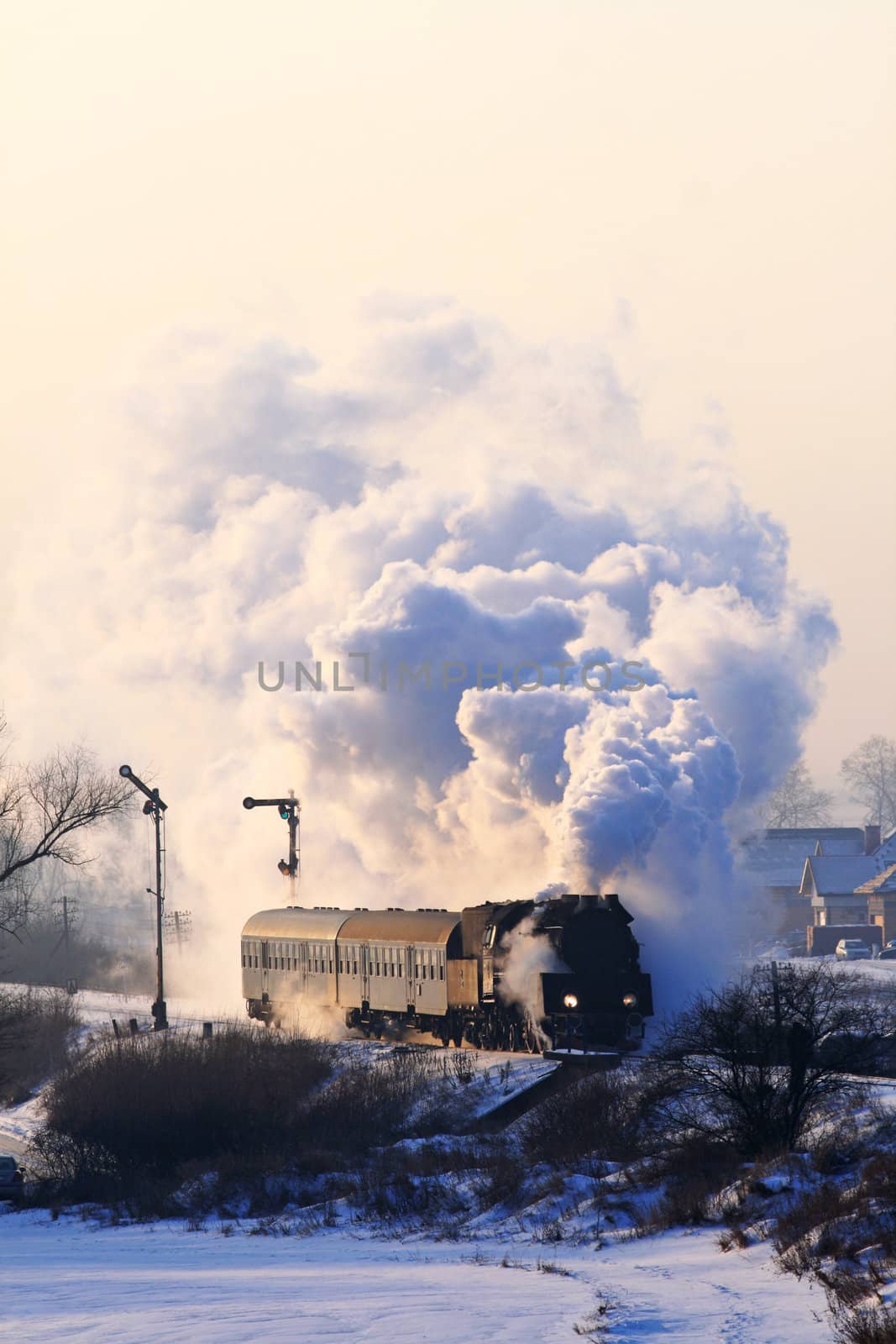 Vintage steam train starting from the station during wintertime