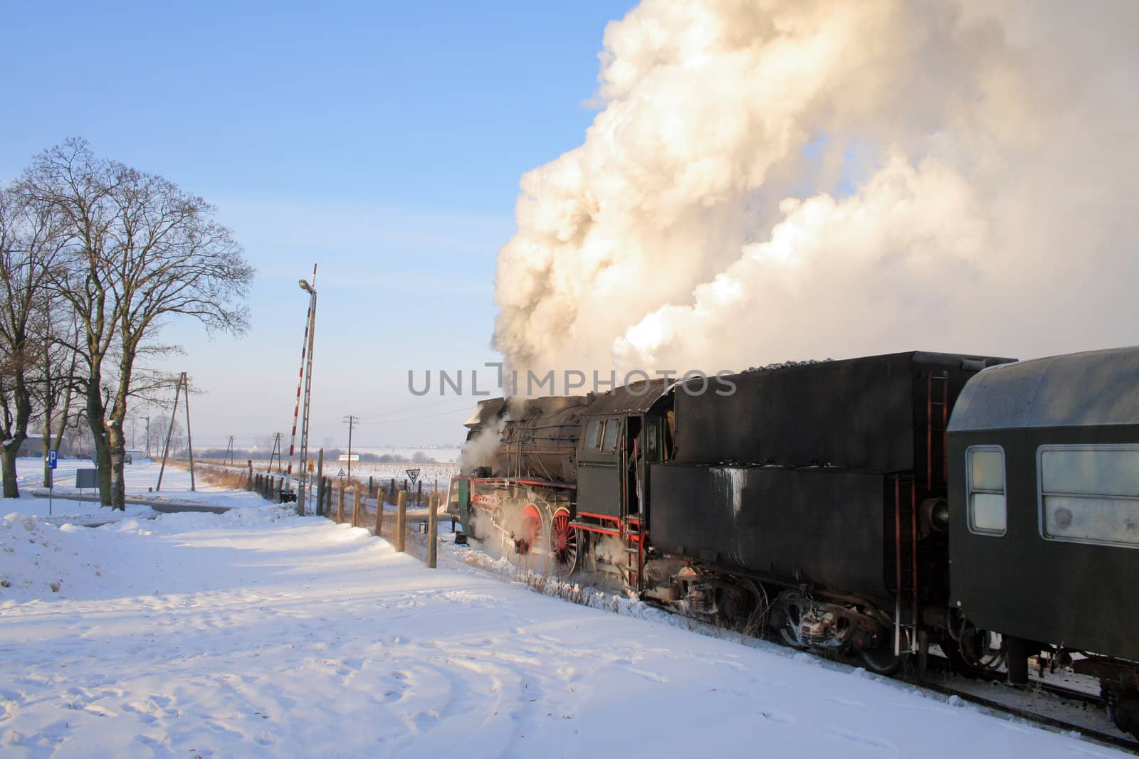 Vintage steam train starting from the station, wintertime