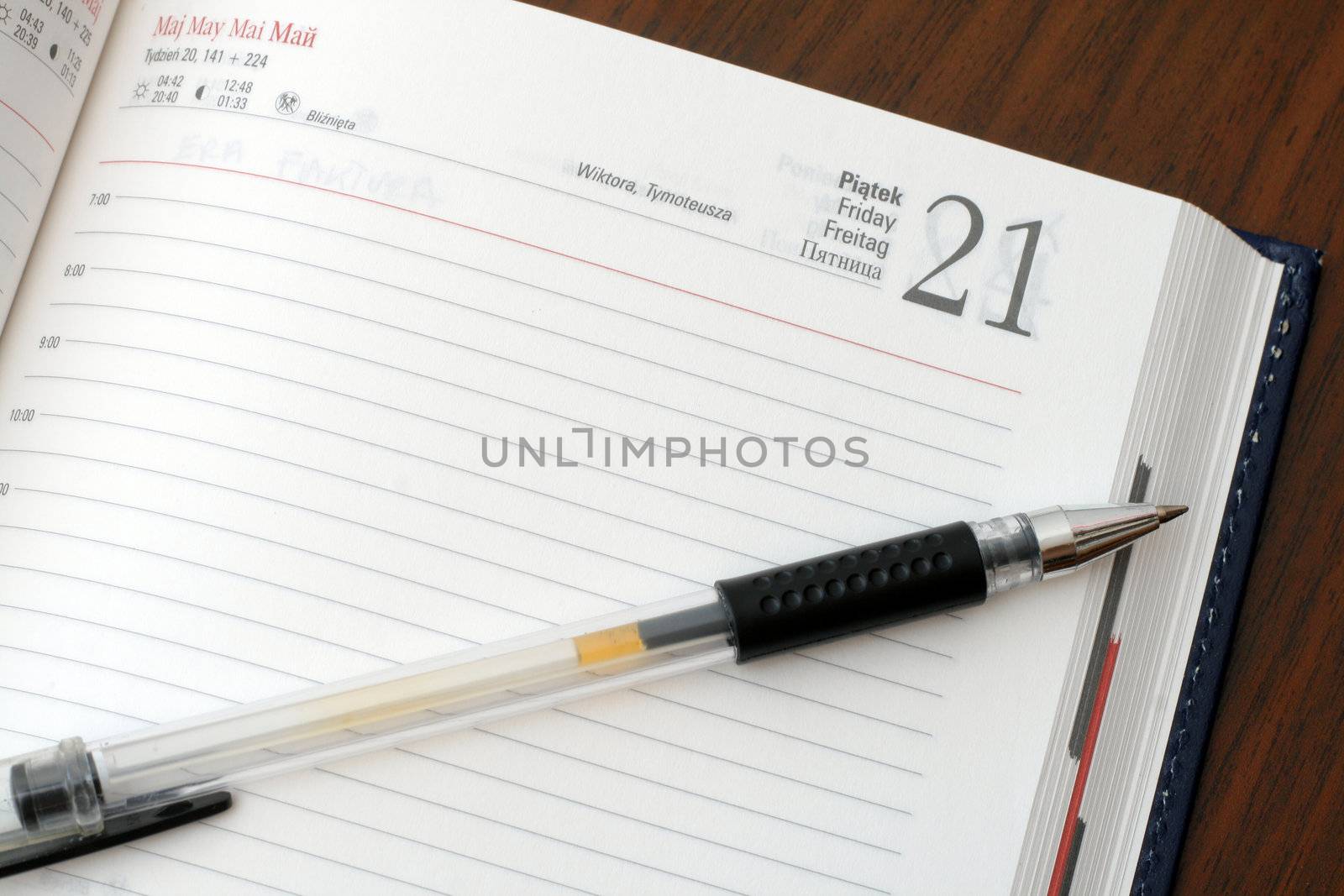 Diary and a pen on wooden table