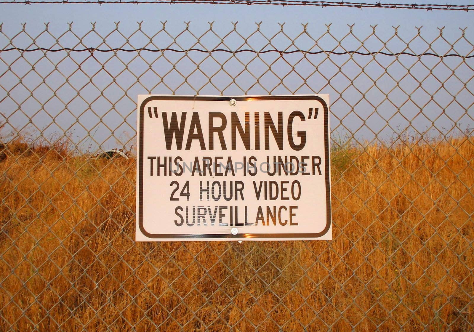 Premises under 24 hour surveillance warning sign.