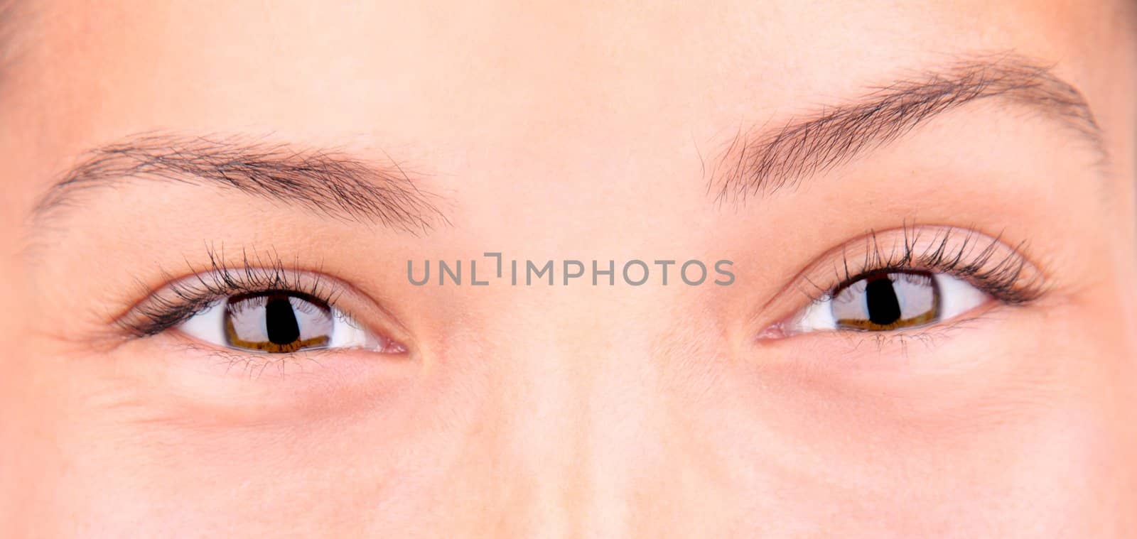 Eyes. Closup of beautiful smiling brown eyes. Mixed race asian / caucasian model