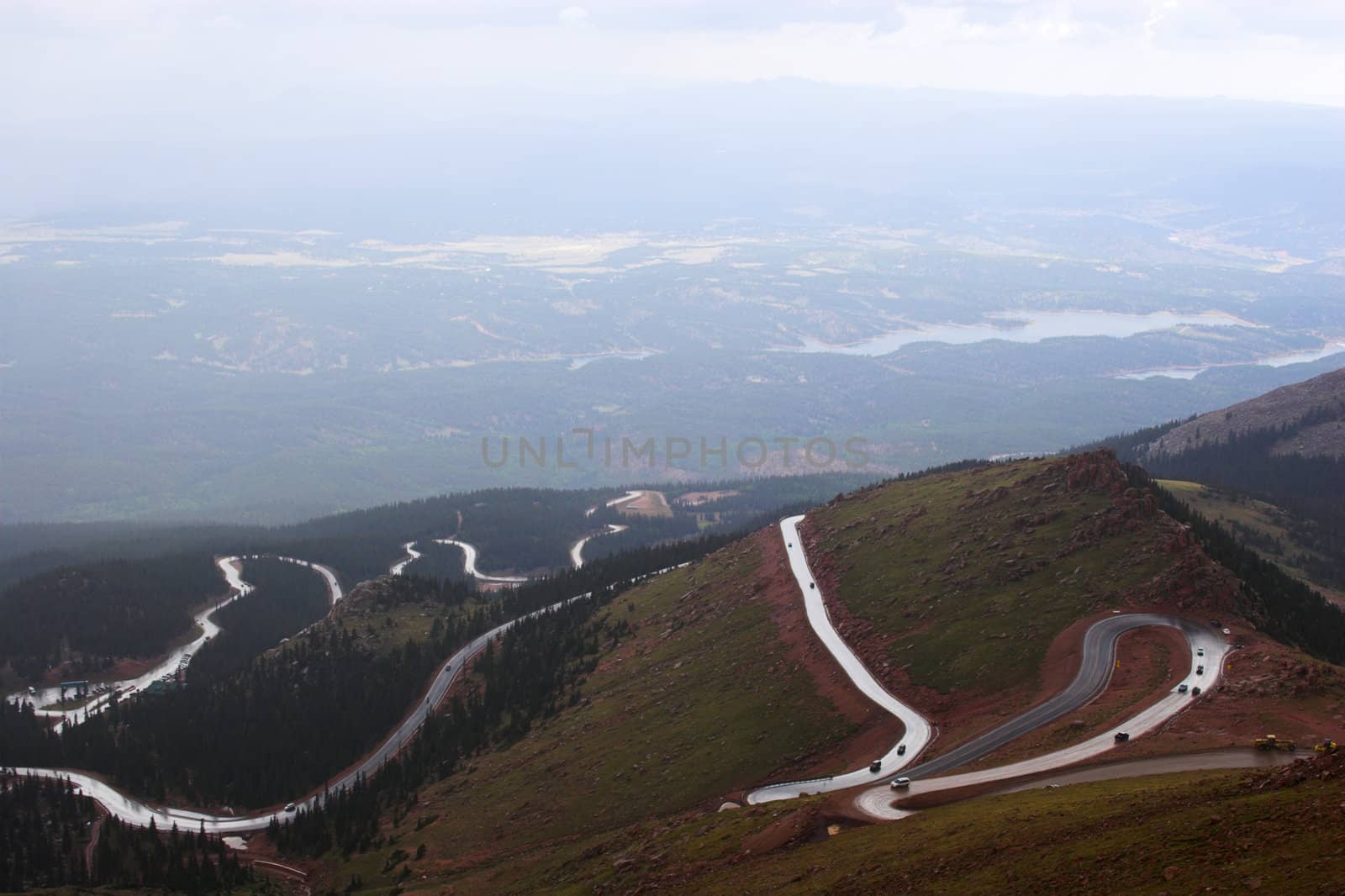 Winding road to Pike�s Peak in Colorado surrounded by colorful mountain prairies during drizzle rain