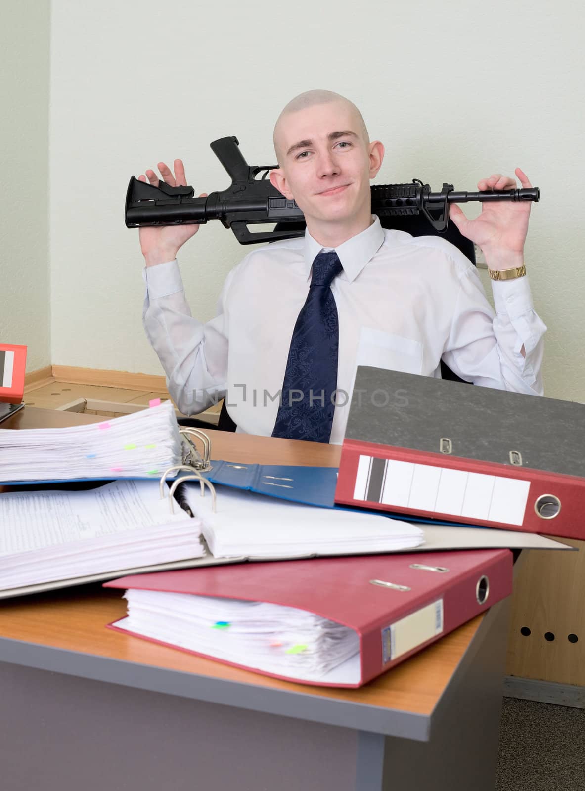 The self-satisfied worker of office armed with a rifle