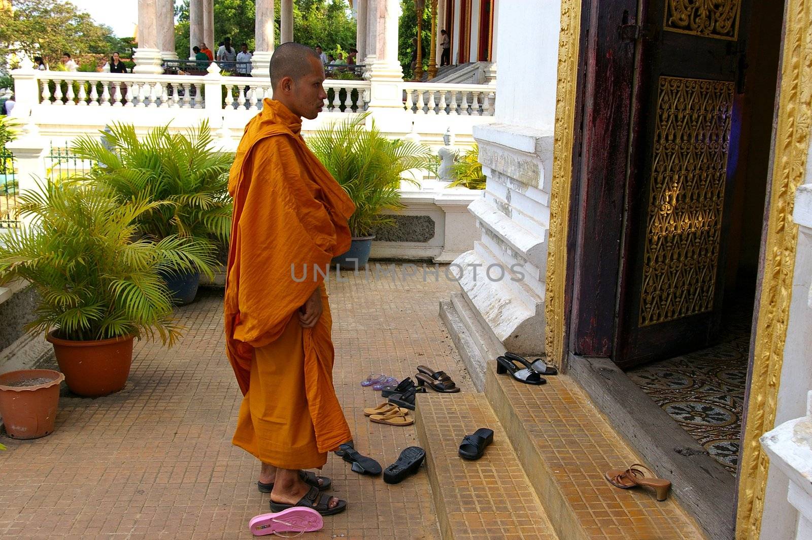 Buddhist Monk entering temple by Komar