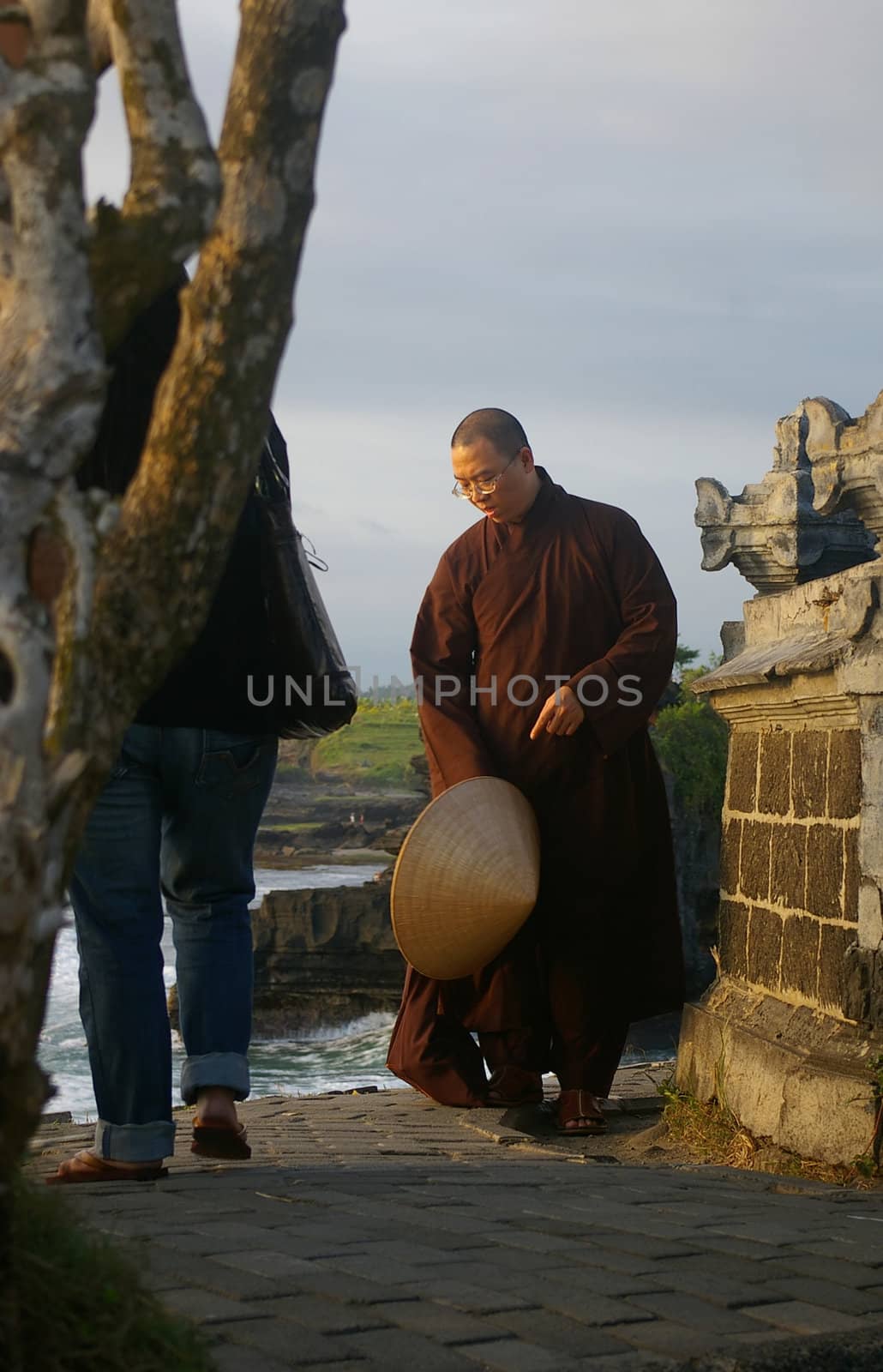 A Vietnamese Buddhist monk visiting temples in Tanah Lot, Bali, Indonesia.