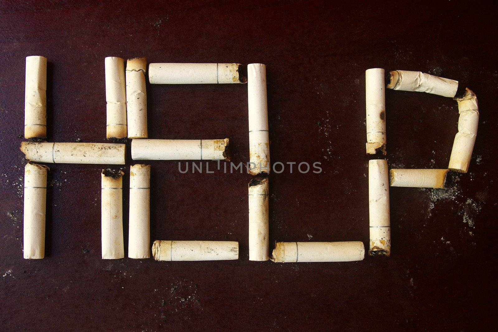 Cigarette butts used to form the word help.