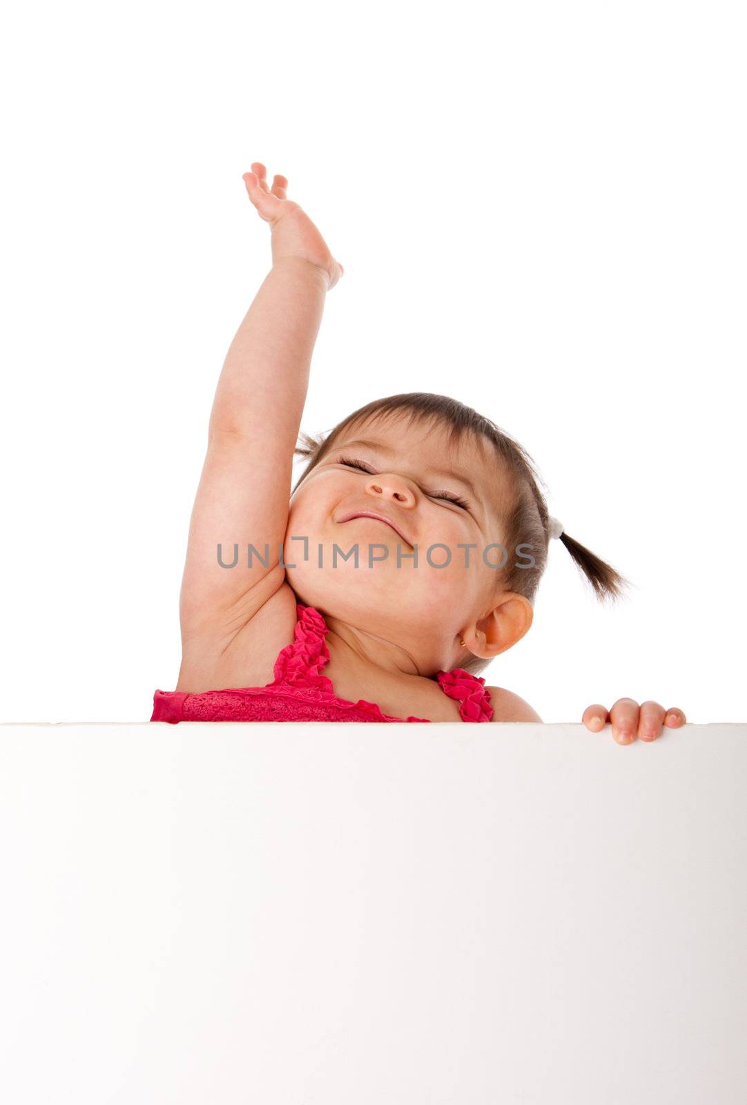 Cute beautiful happy baby infant girl holding white board while reaching up in the air with pride, isolated.