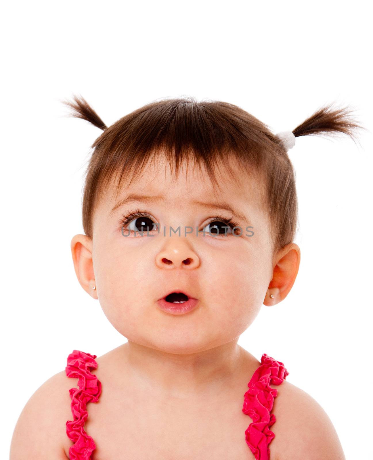 Face of cute surprised baby infant girl with ponytails, making funny mouth expression, isolated.