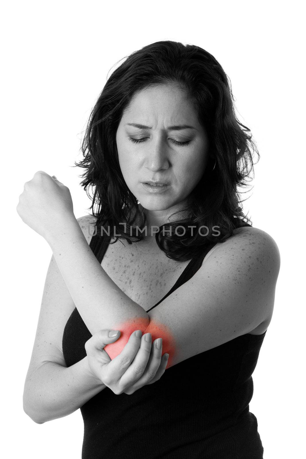 Beautiful woman holding her elbow with pain and arm ache,wearing a sporty black tank top, isolated.