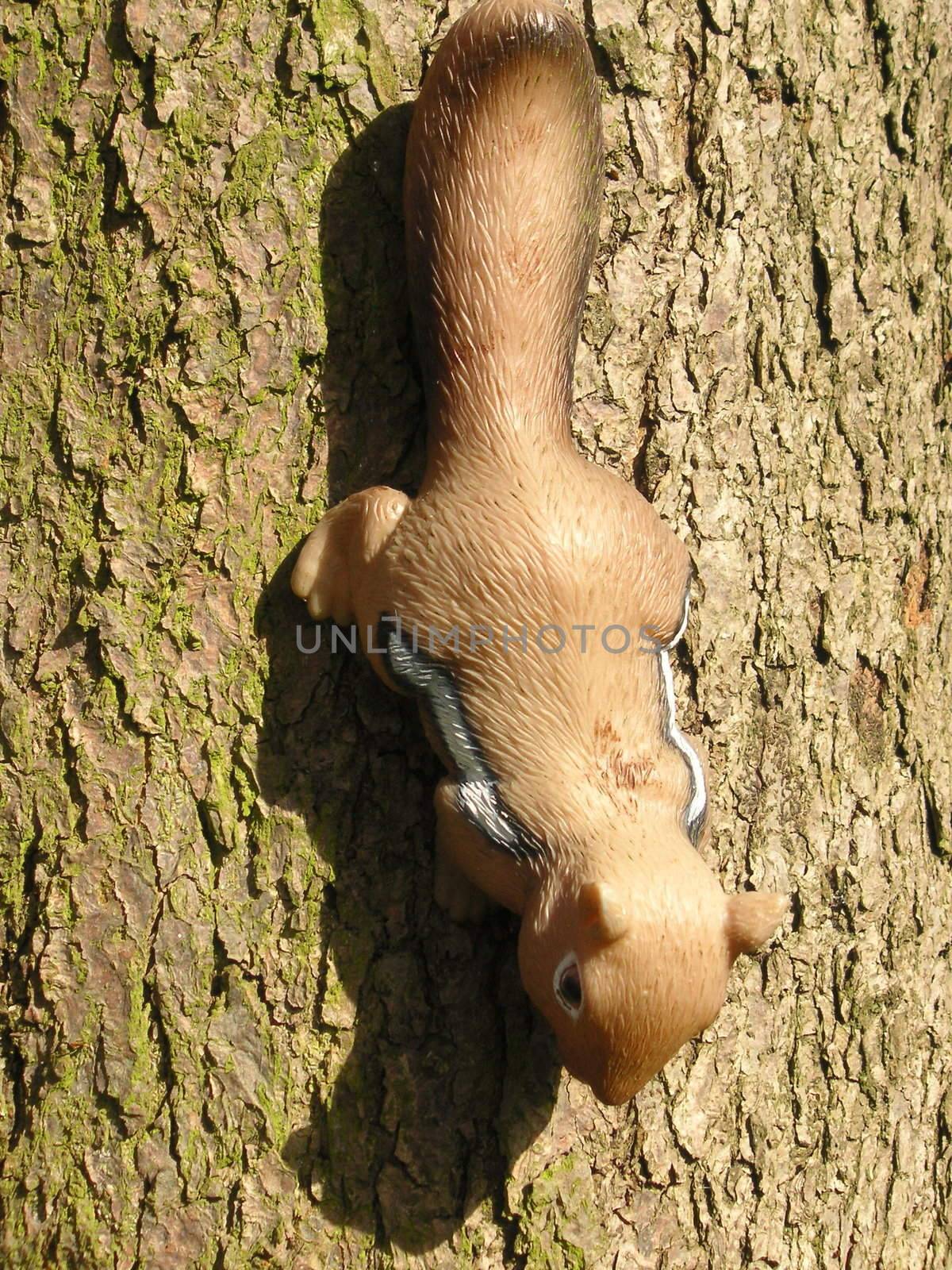 toy squirrel ornament set as if climbing on a tree