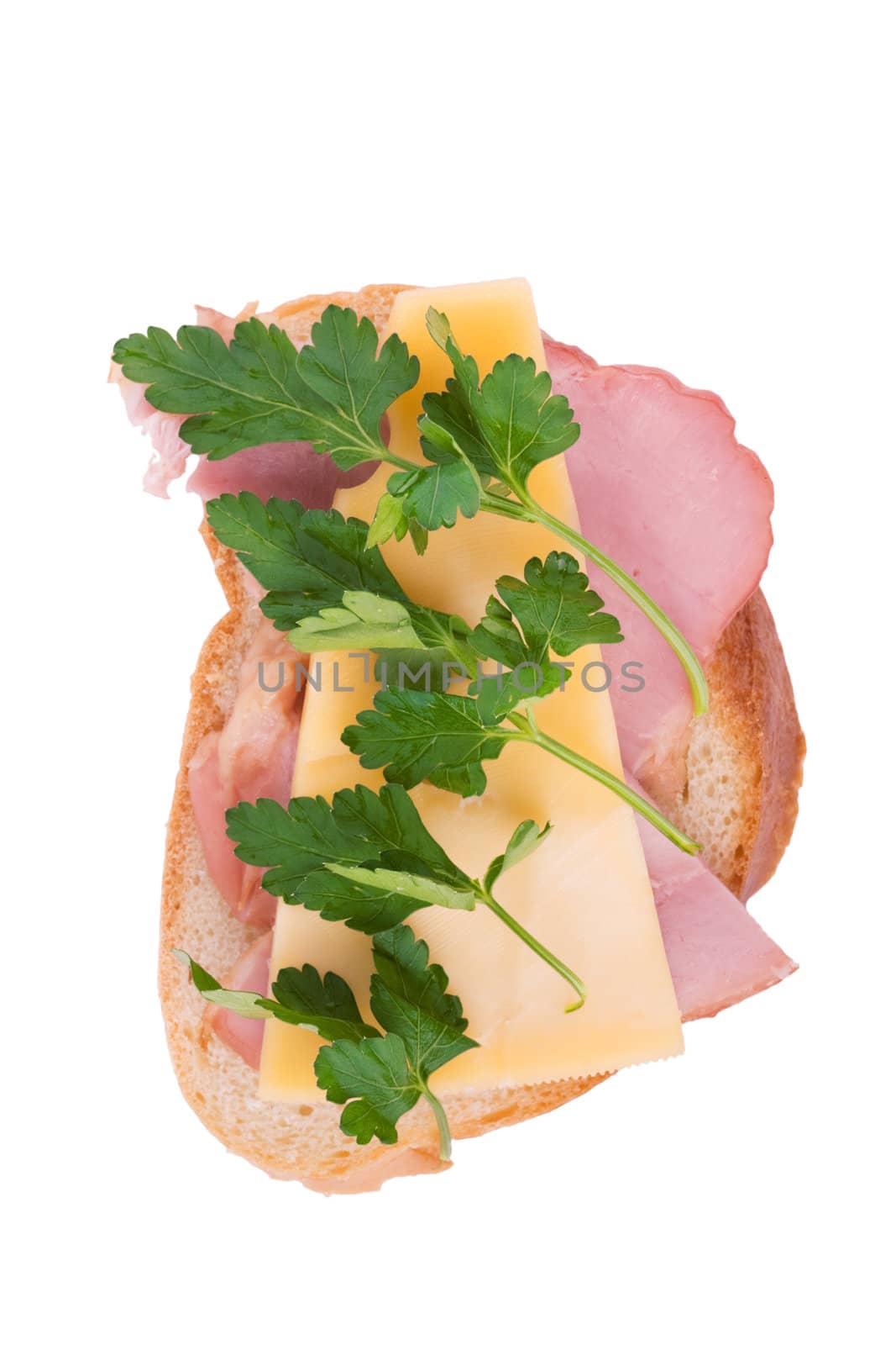 Open faced sandwich with ham, cheese and parsley isolated over white