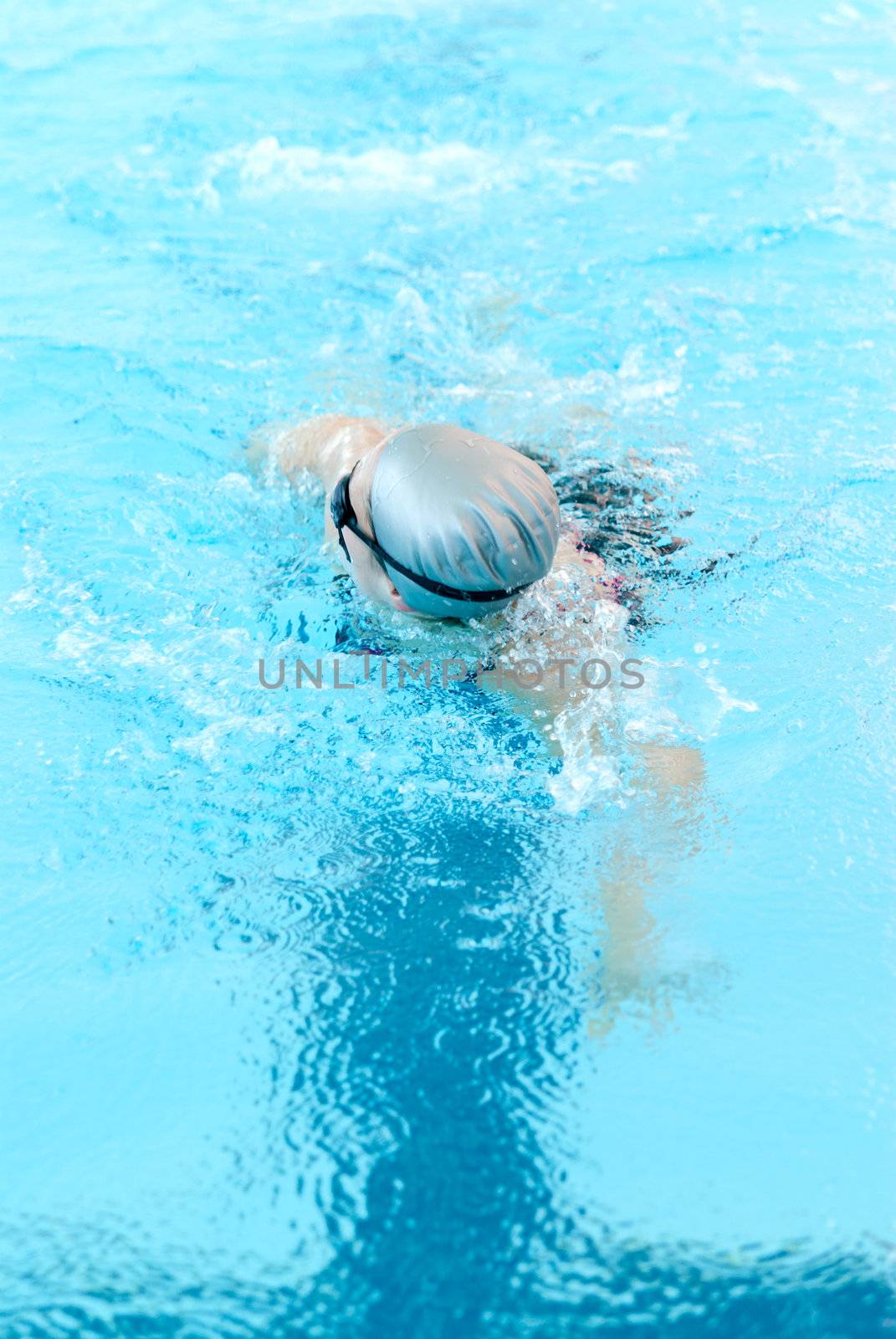 young woman swim on indoor pool close-up. freestyle mode