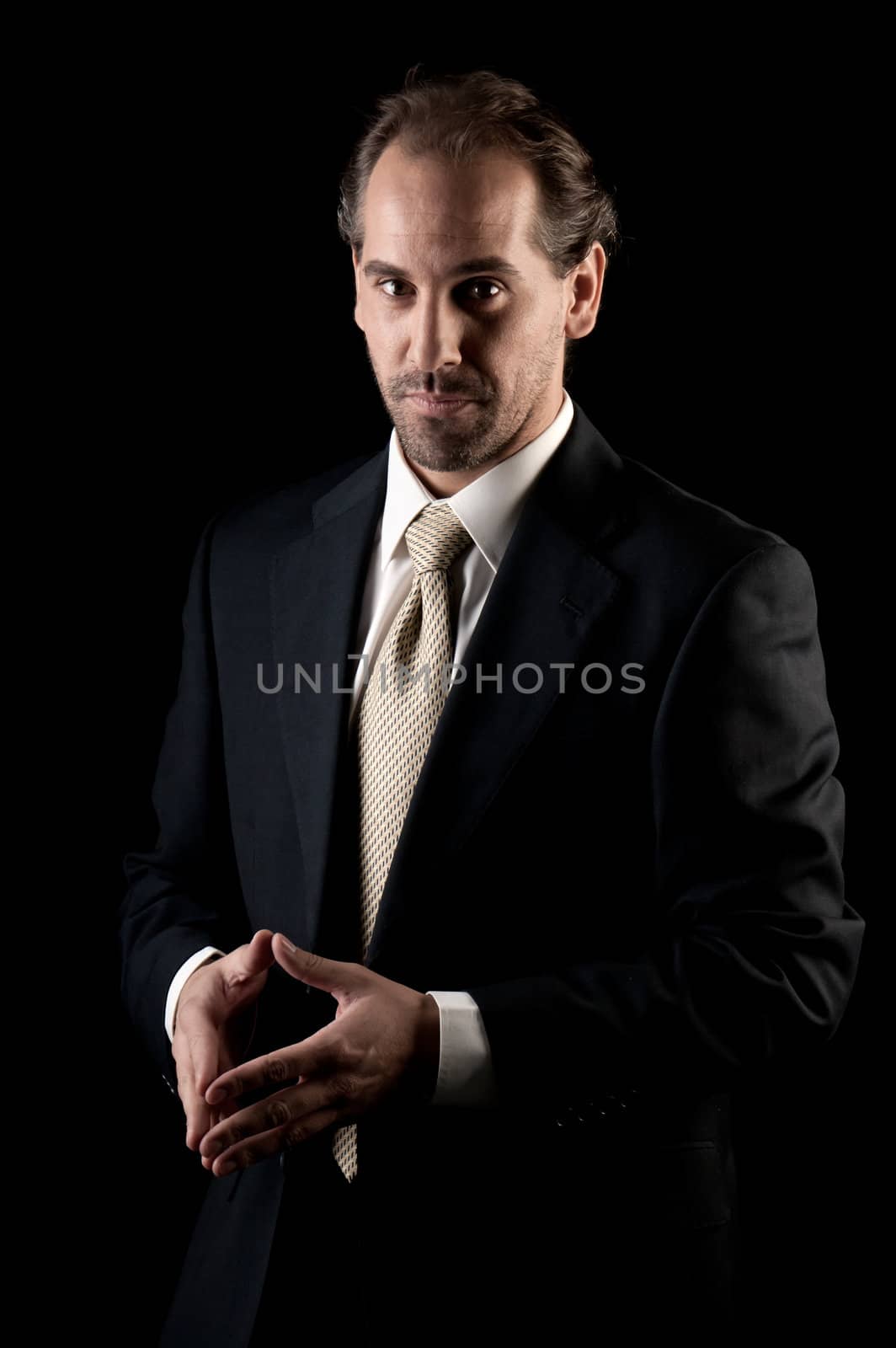 Adult businessman serious hands gesture on black background by dgmata