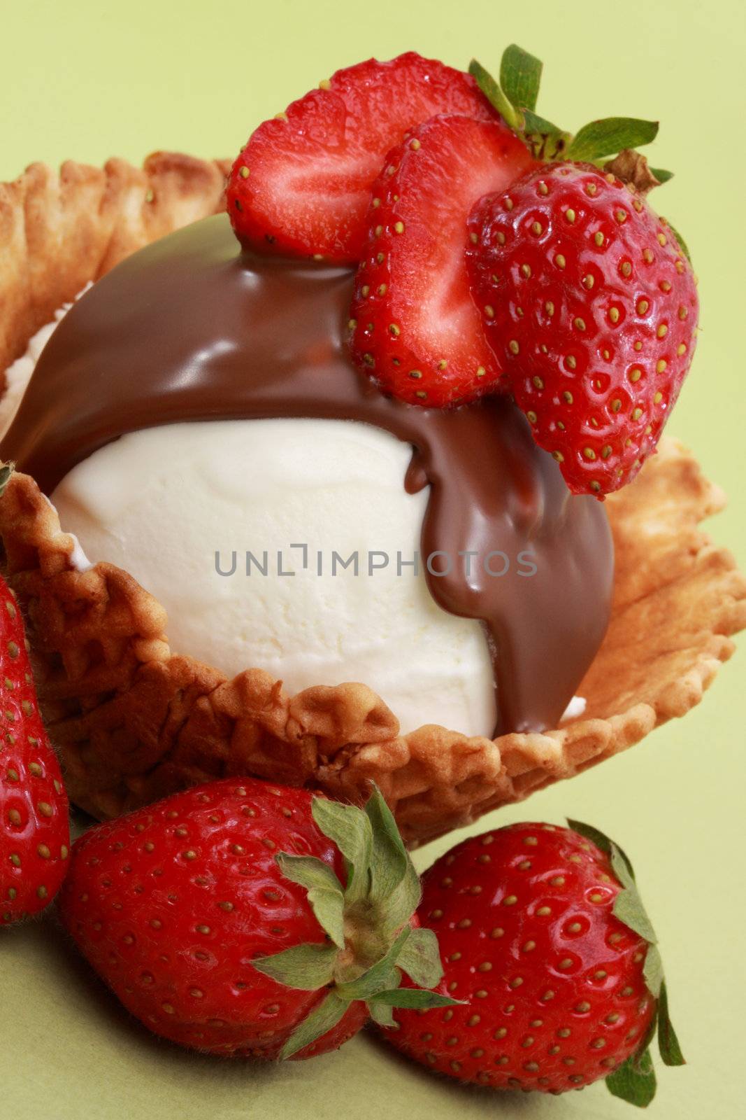vanilla ice-cream in a wafer basket with chocolate and strawberries