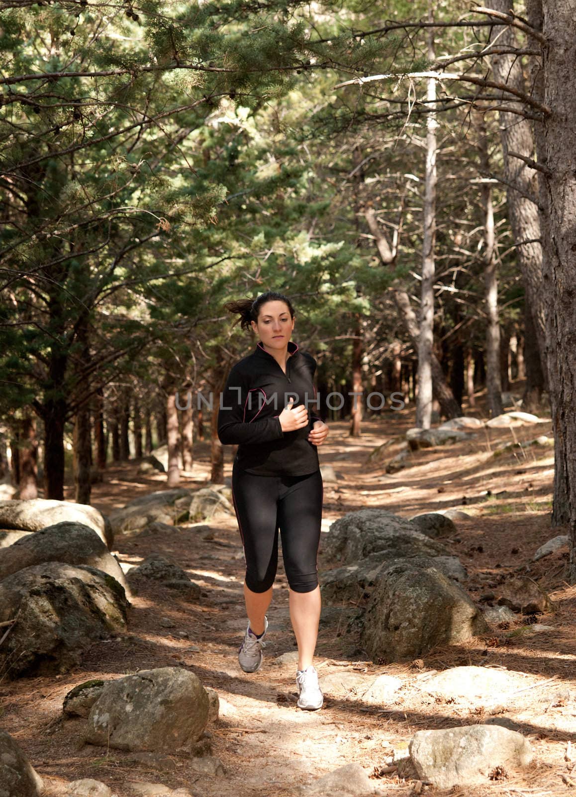 Young woman running on woods, outdoor background