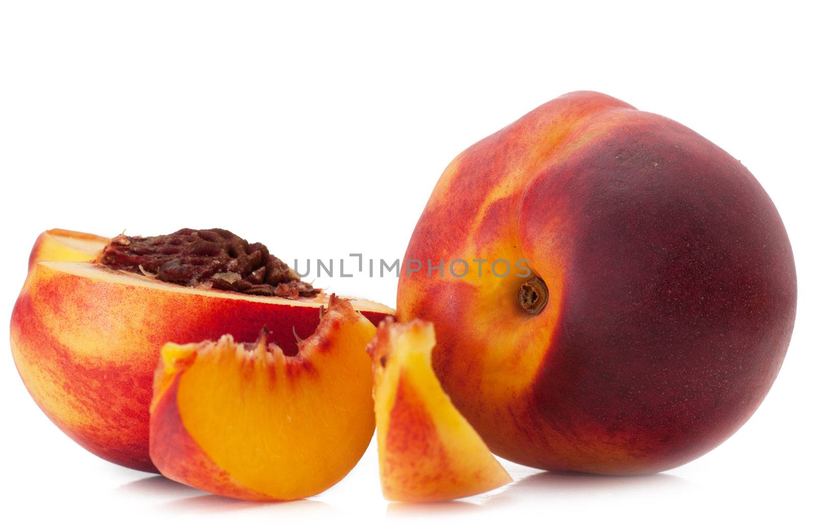 Tasty juicy peaches and slices of peaches on a white background