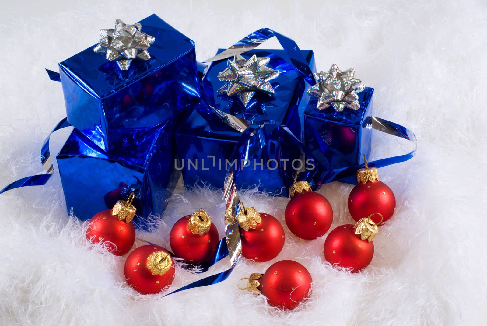 Blue boxes and Christmas red balls on the white skin