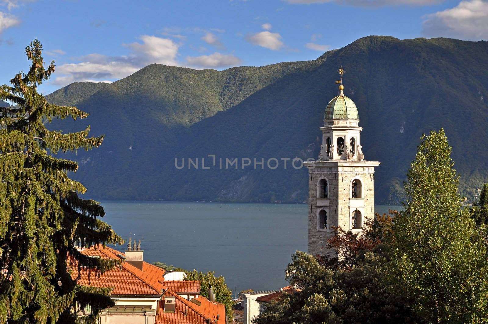 View from Lugano, Switzerland with church tower and lake.