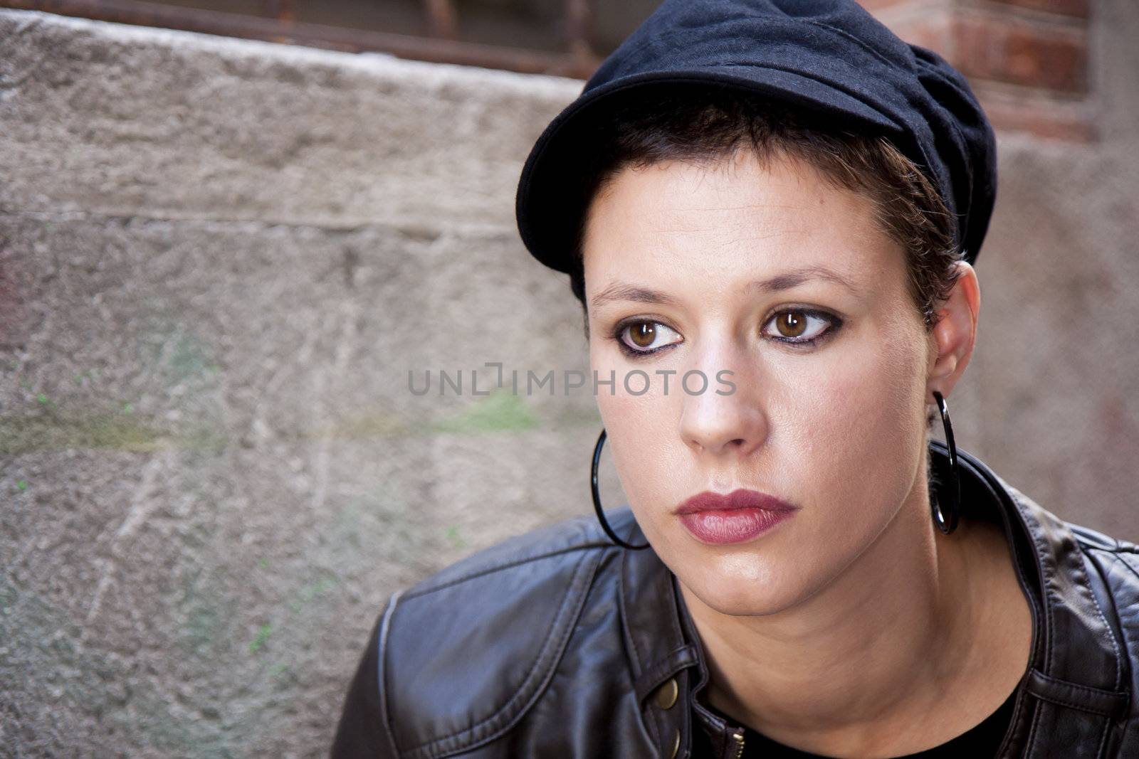 portrait of a young woman, staring into his thoughts, a cap on his head