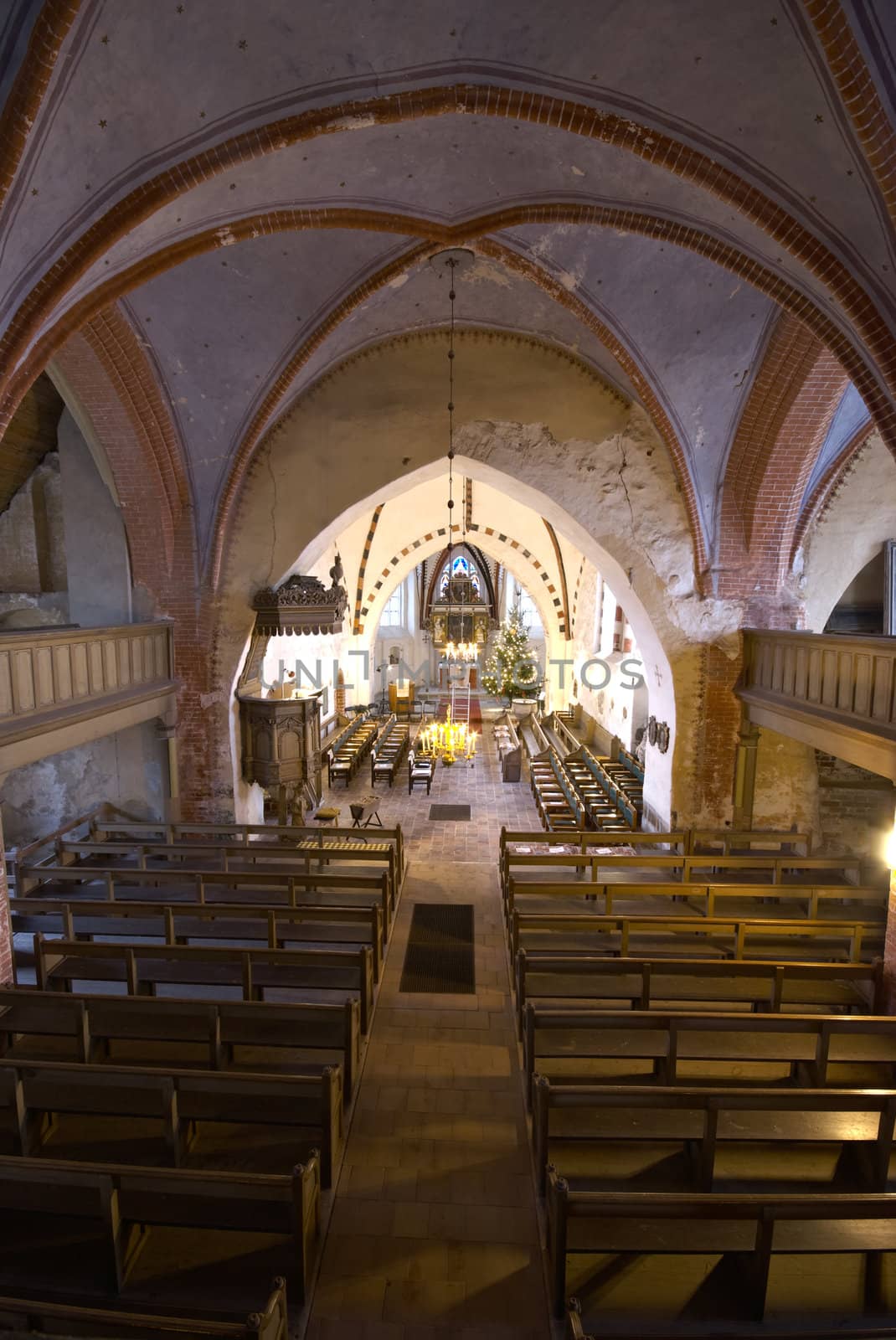 inside of a village church decorated for christmas