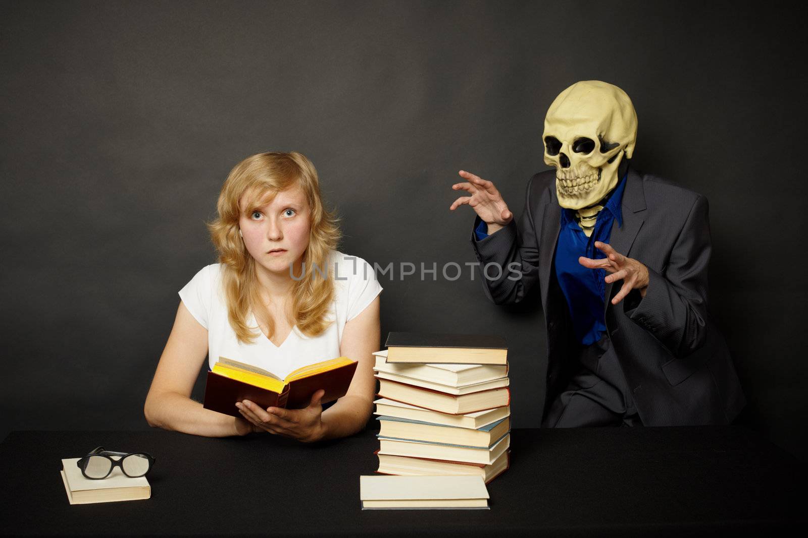 Young woman reading a terrible book in the dark