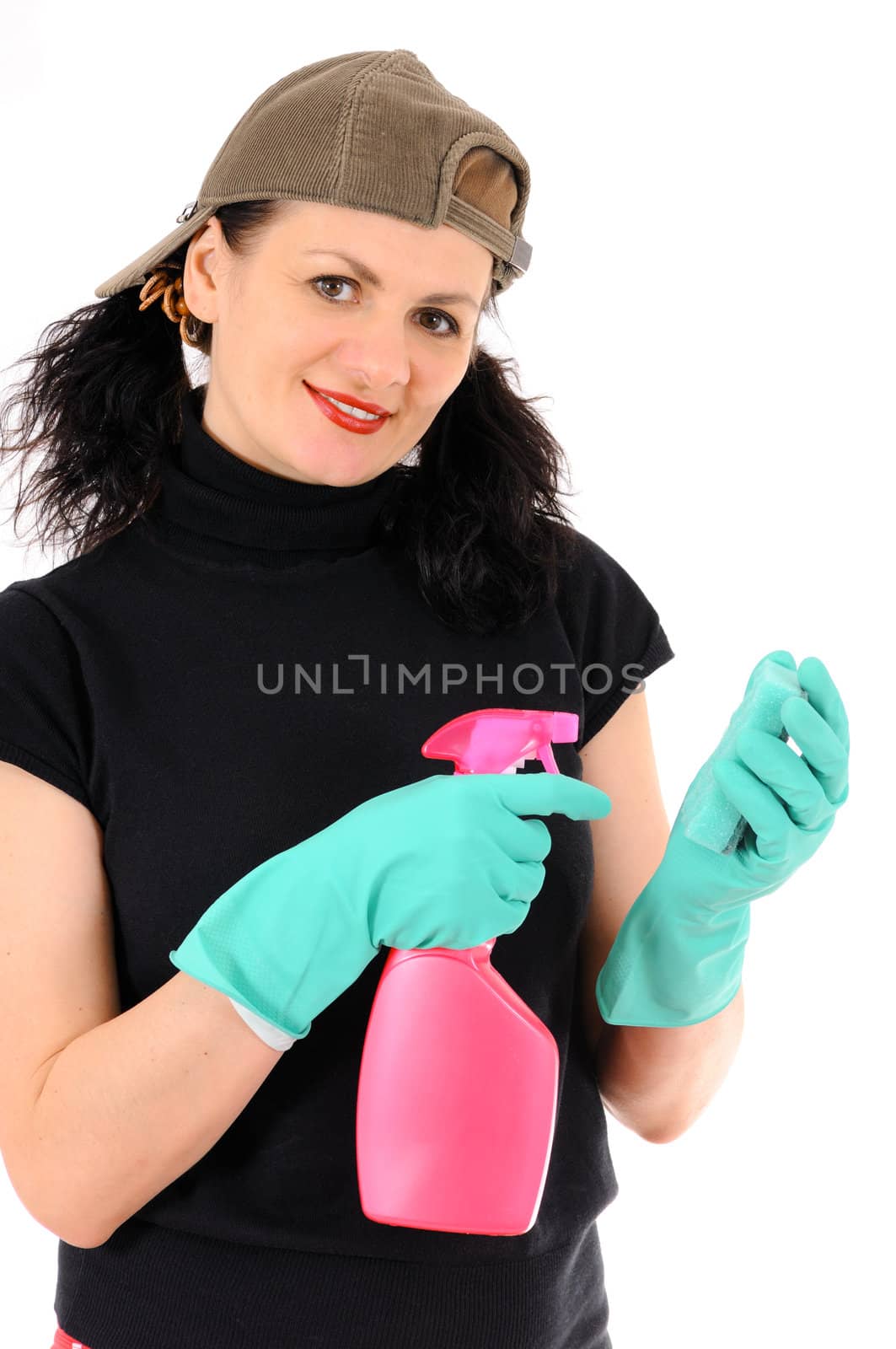 The woman in a cap and green gloves washes a window