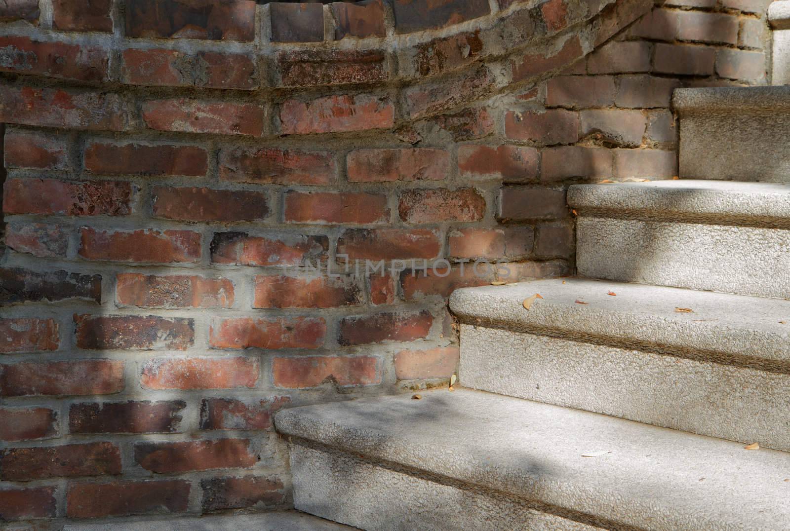 Curved brick wall joined to stone staircase