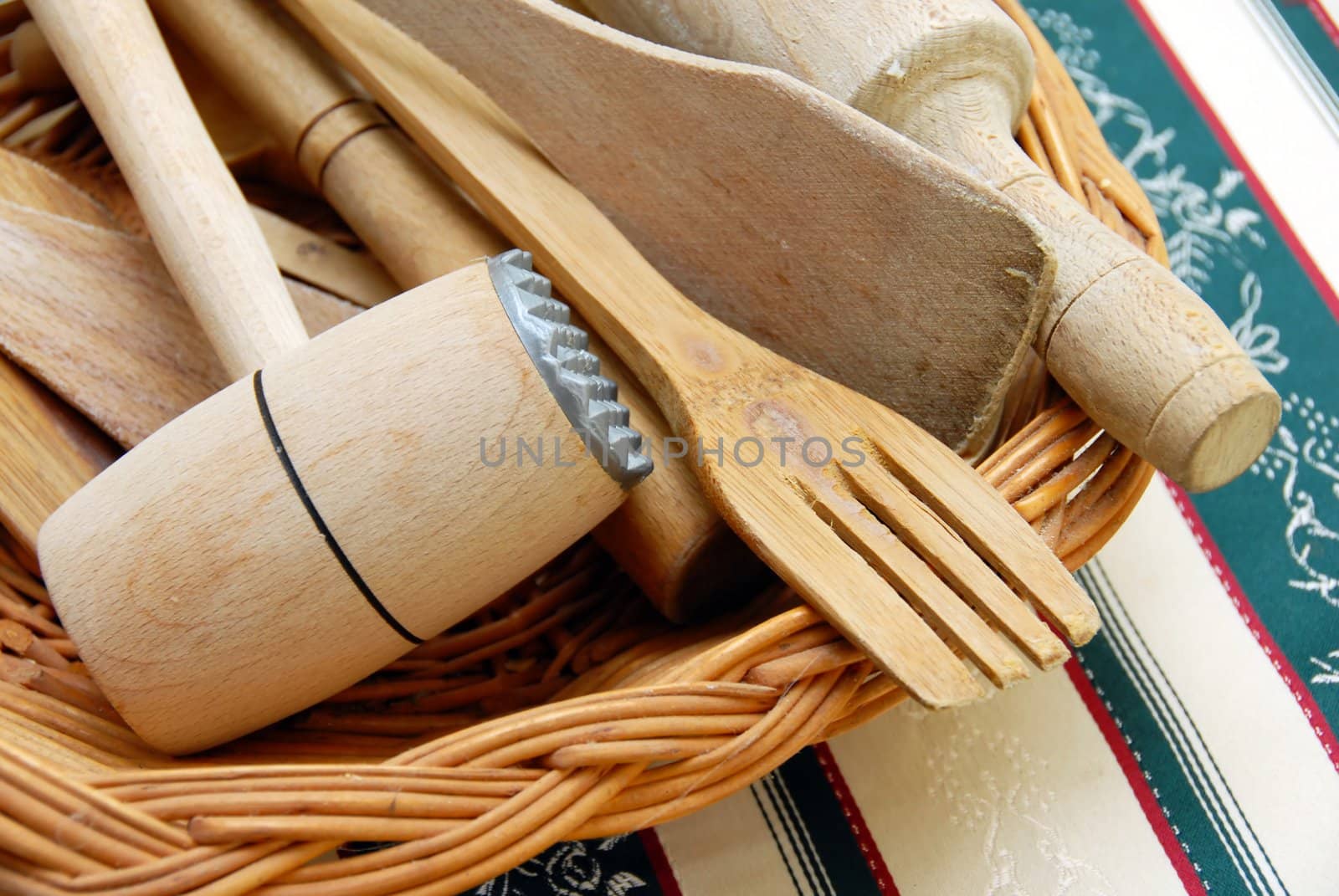 wooden kitchen equipment, meat hummer and scoops closeup on table