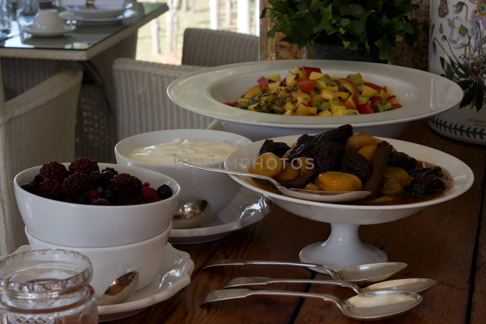 Breakfast buffet of  fruit bowls with silver serving spoons