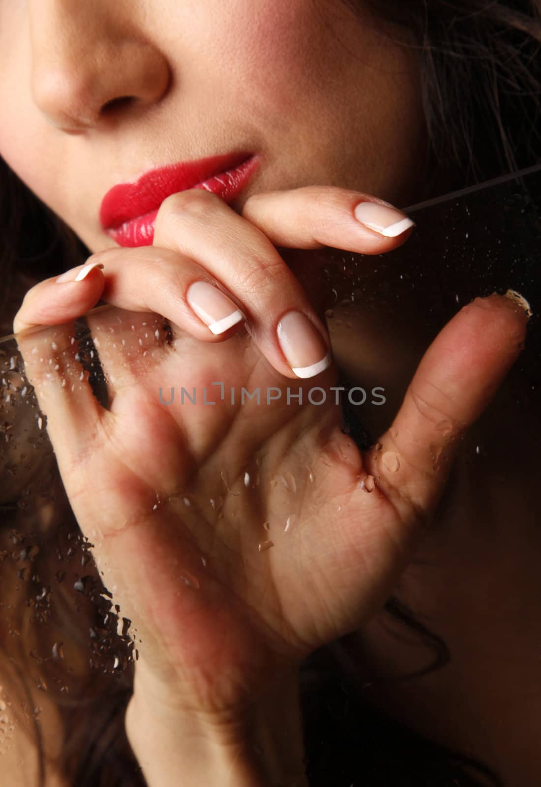 Beautiful female hand with wet glass