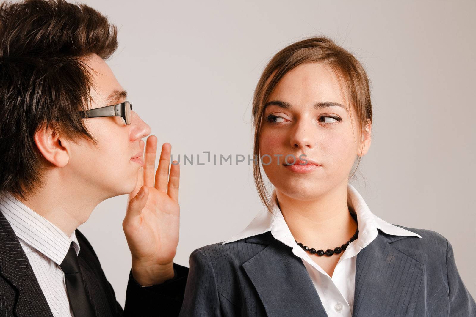 Businessman whispering to his partner