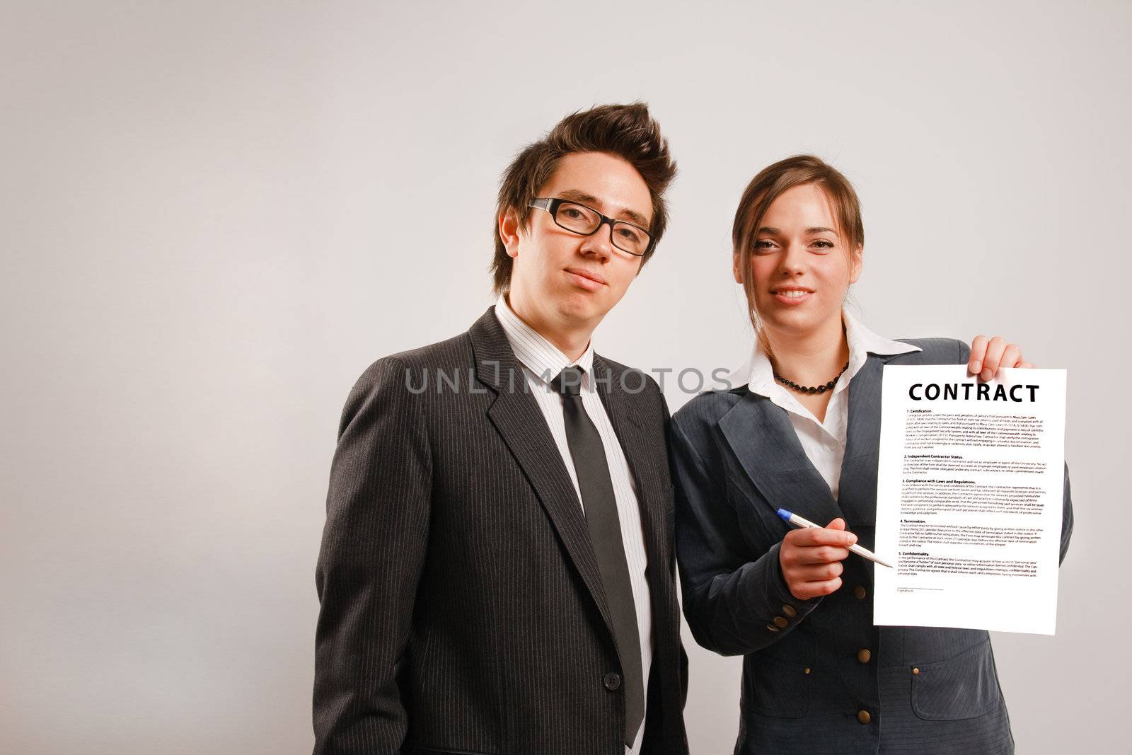 Two business partners holding a printed contract