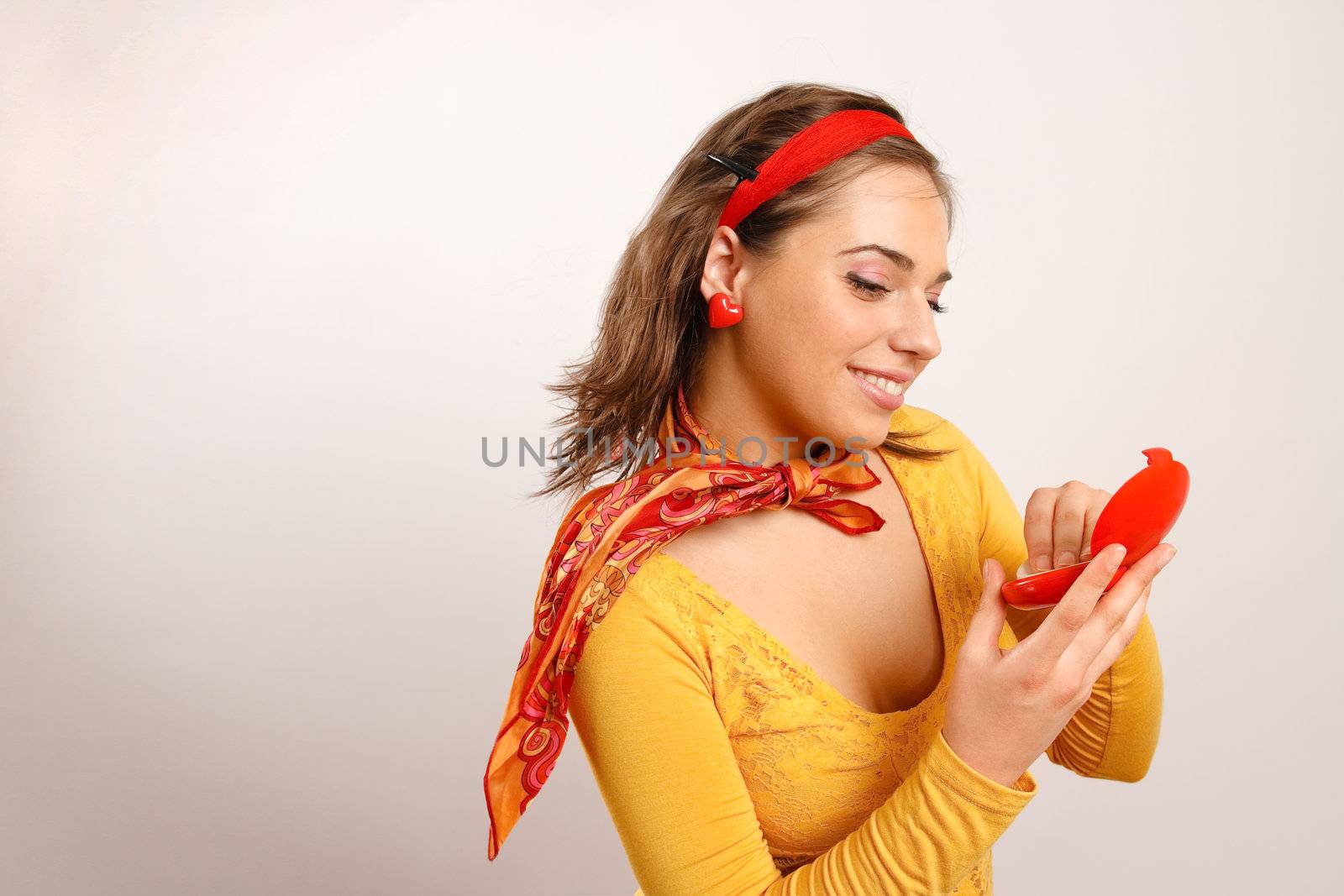 Stylish and attractive young woman looking in the mirror by photovibes