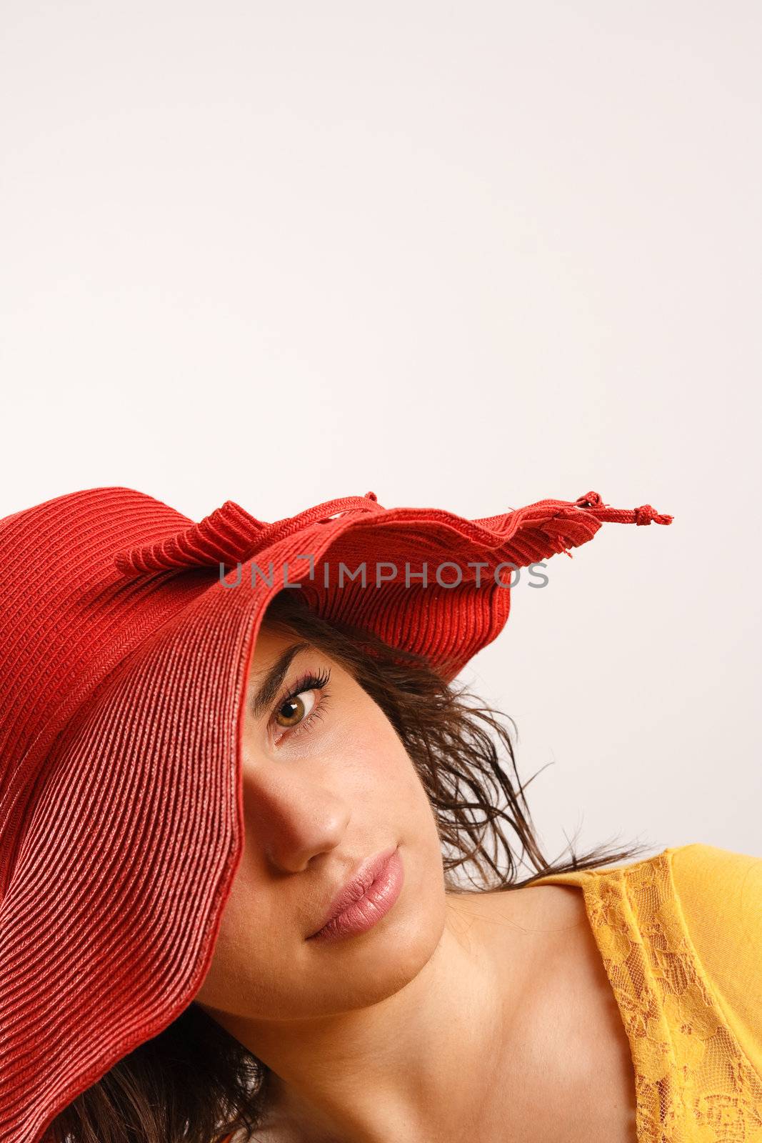 Portrait of attractive beautiful young woman wearing red hat by photovibes