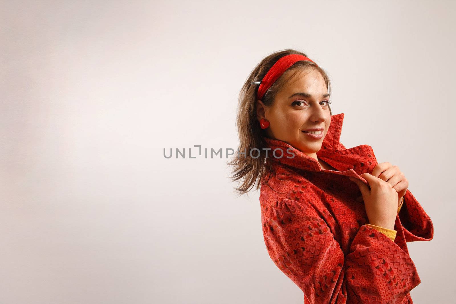 Portrait of attractive beautiful young woman wearing red jacket by photovibes